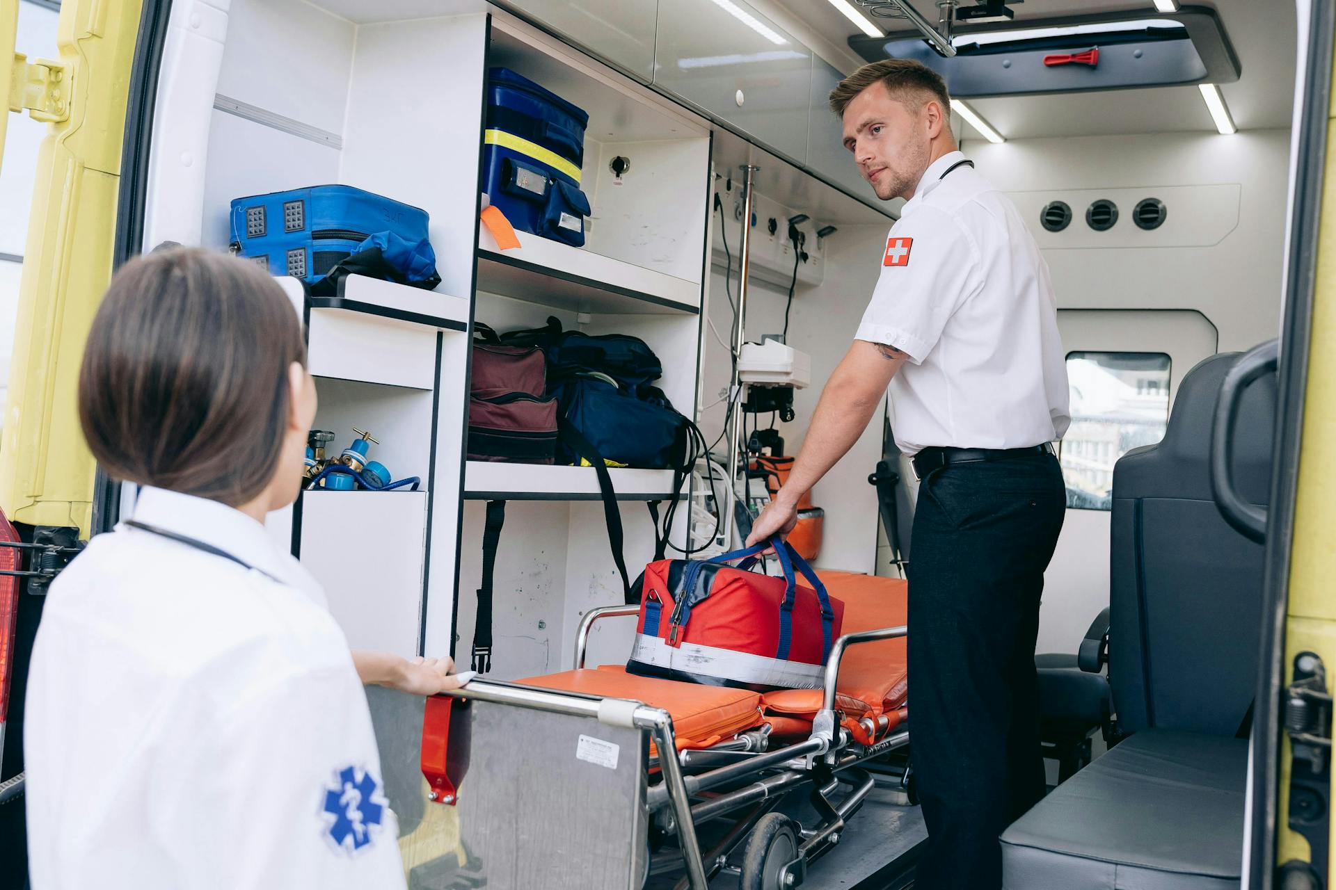 Sjukvårdare tar hjälpväska från Gurney