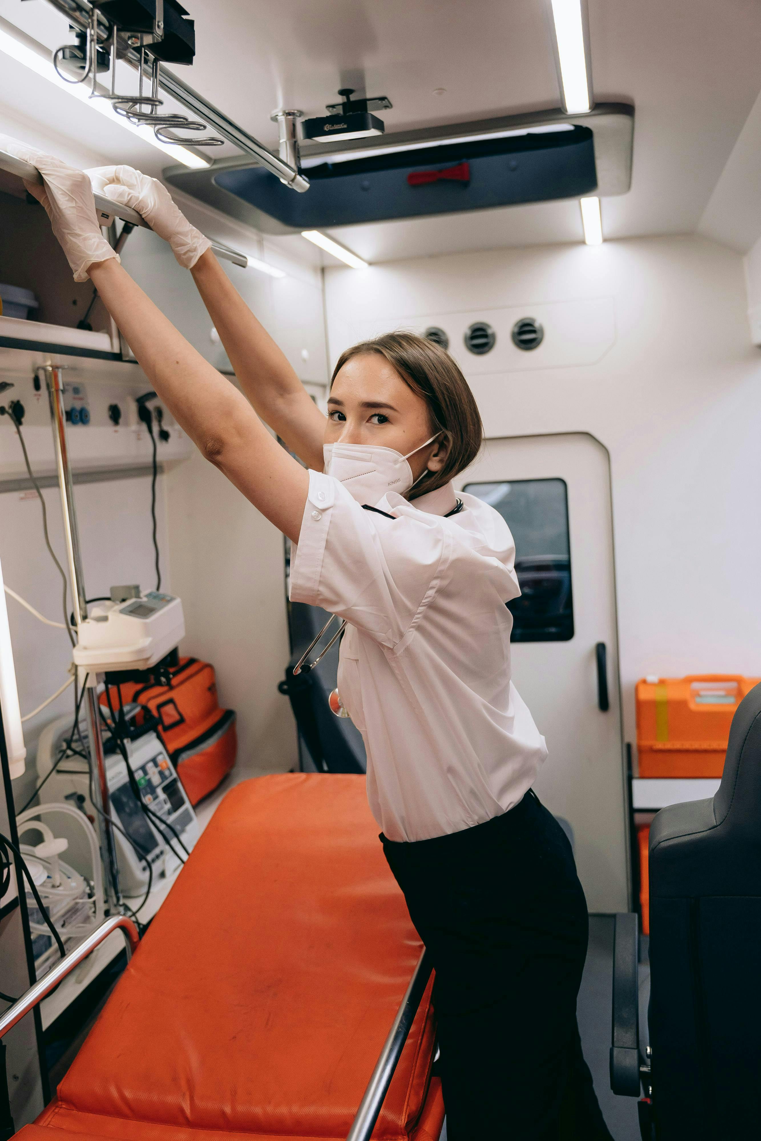 paramedic reaching into the cabinet in the ambulance