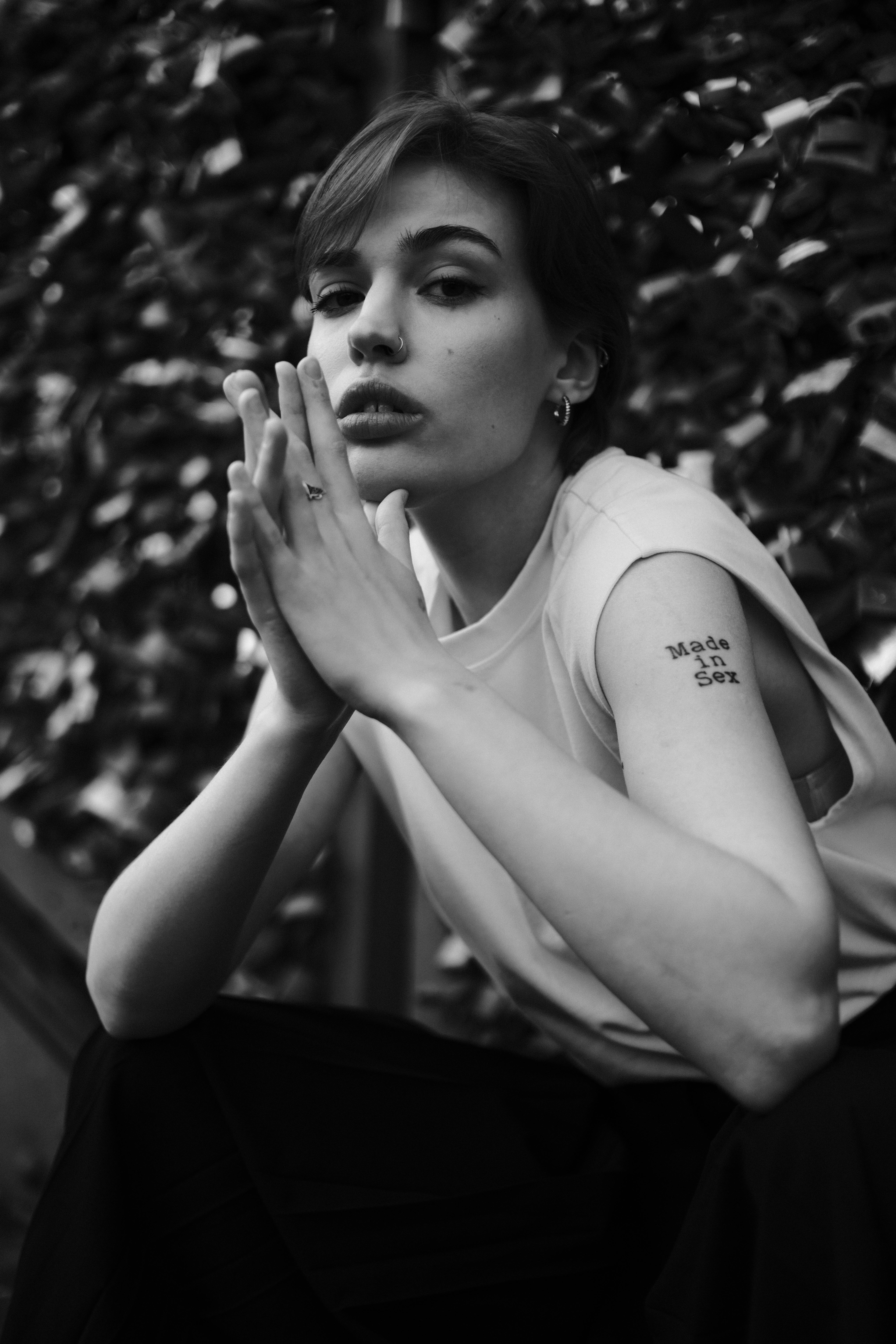 a woman with tattoos sitting on a bench