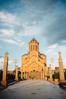 A majestic view of the Tbilisi Holy Trinity Cathedral at sunset showcasing its architectural beauty.
