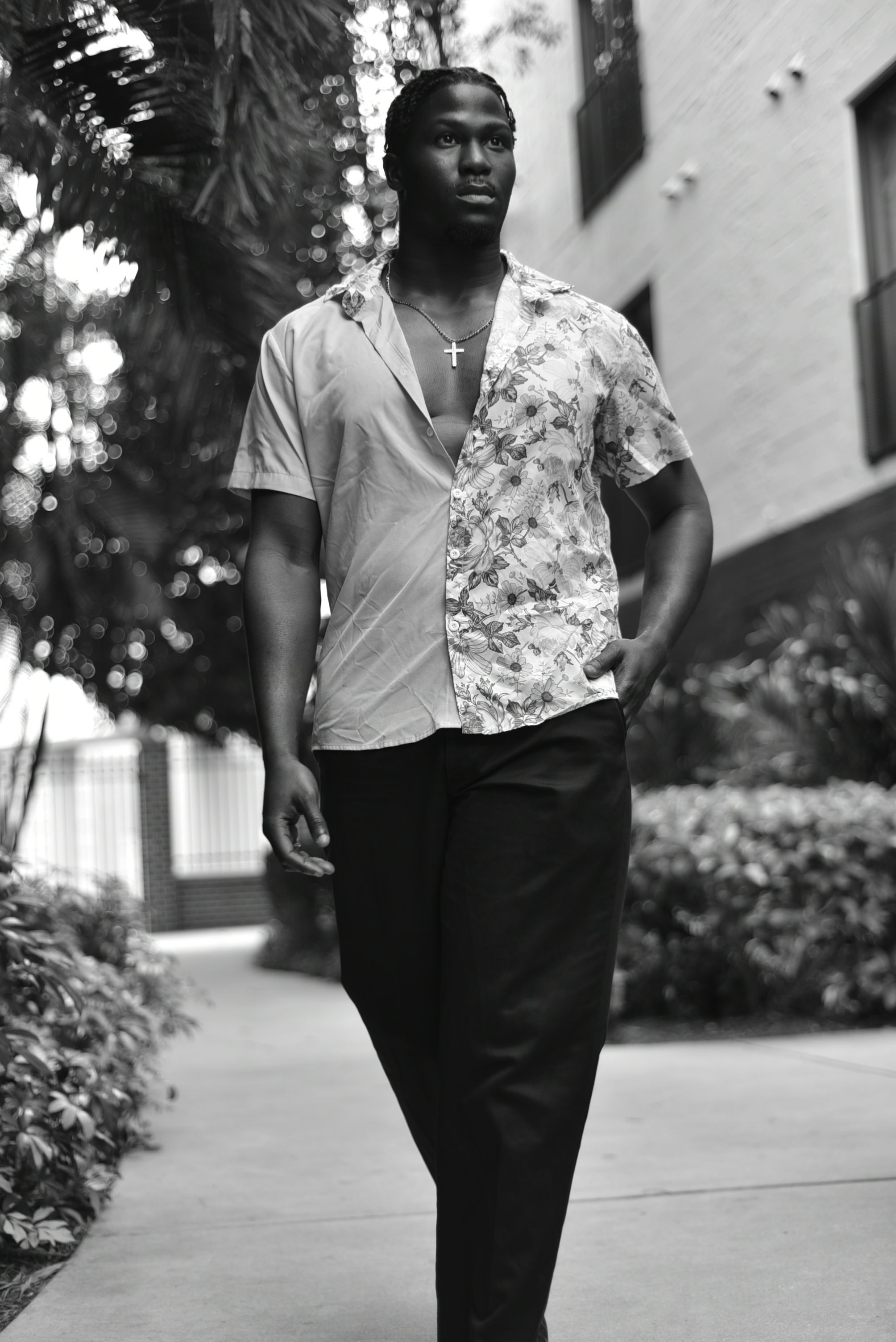 Black and white portrait of a fashionable man walking in an urban setting in Orlando.