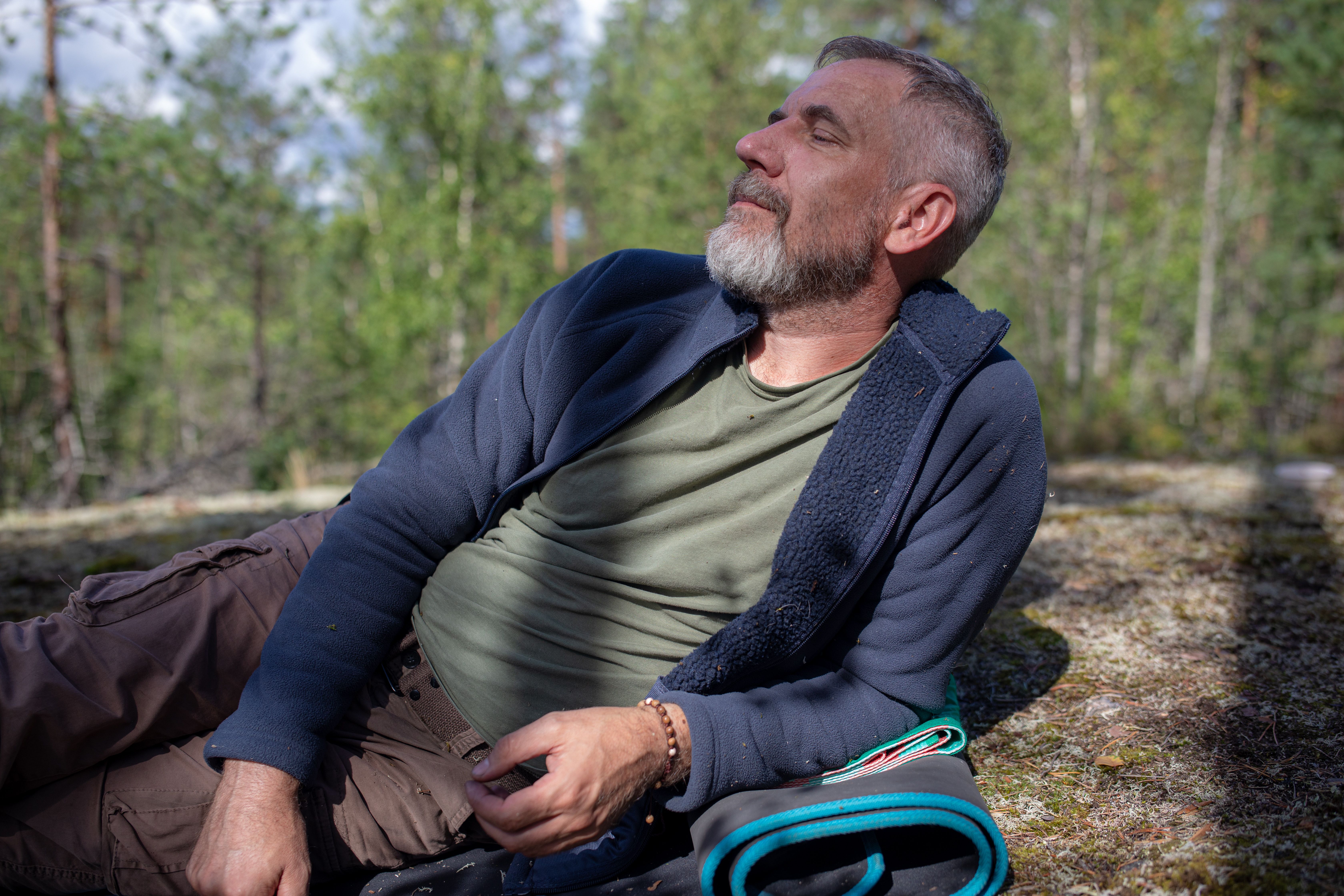 Middle-aged man resting outdoors after a hike