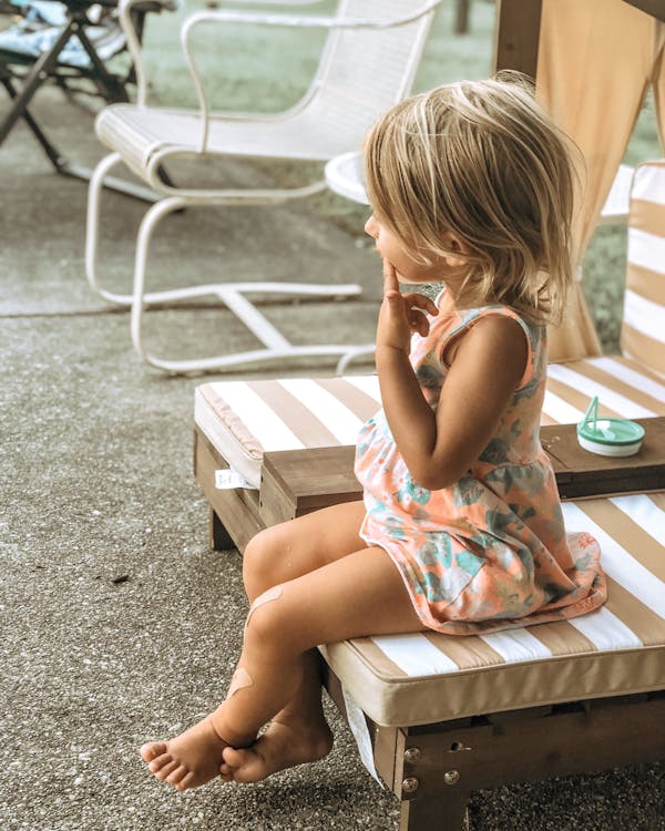 Free Photo Of Kid Sitting On A Chair Stock Photo