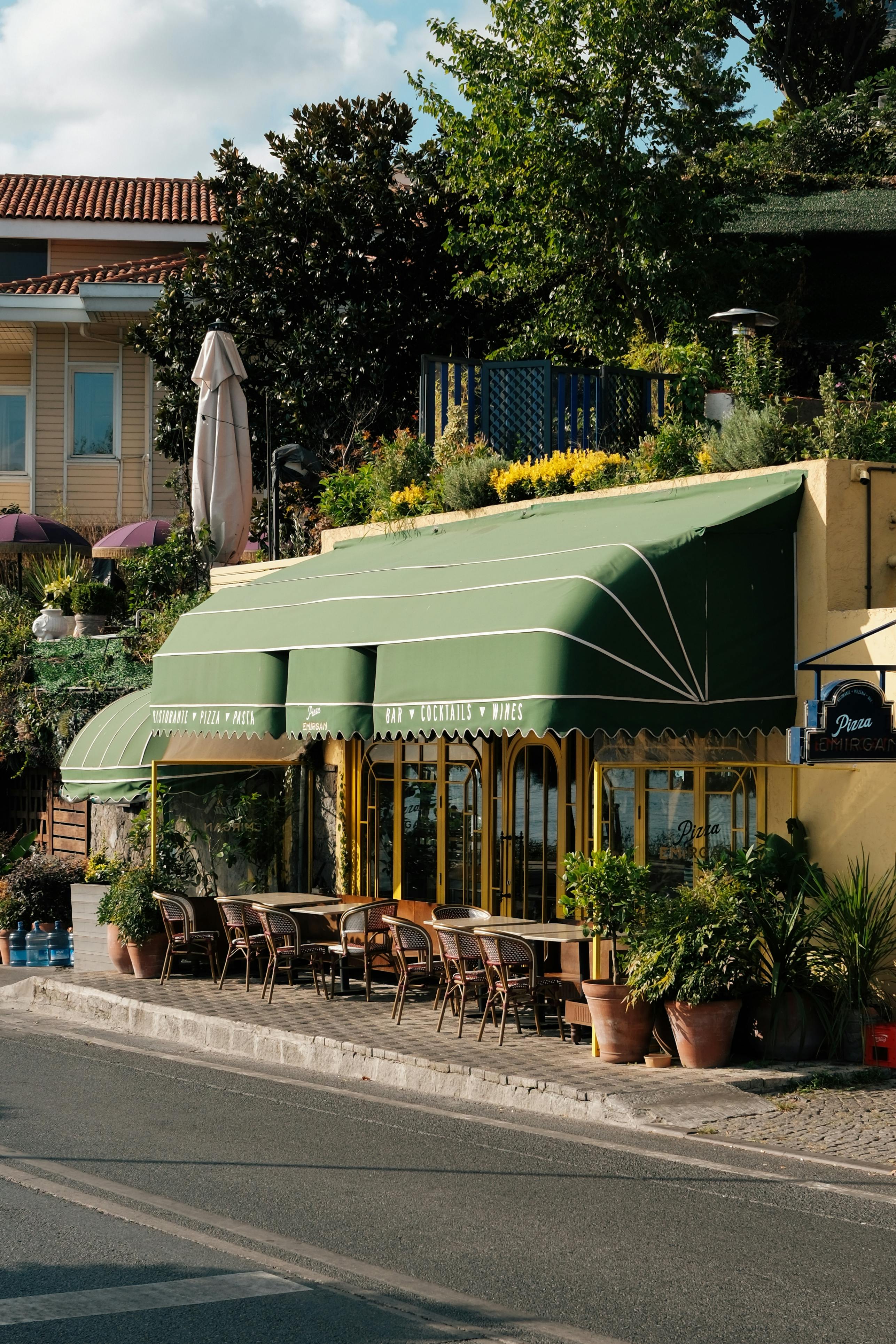 Picturesque outdoor café with green awning on a sunny day in Istanbul, Türkiye.