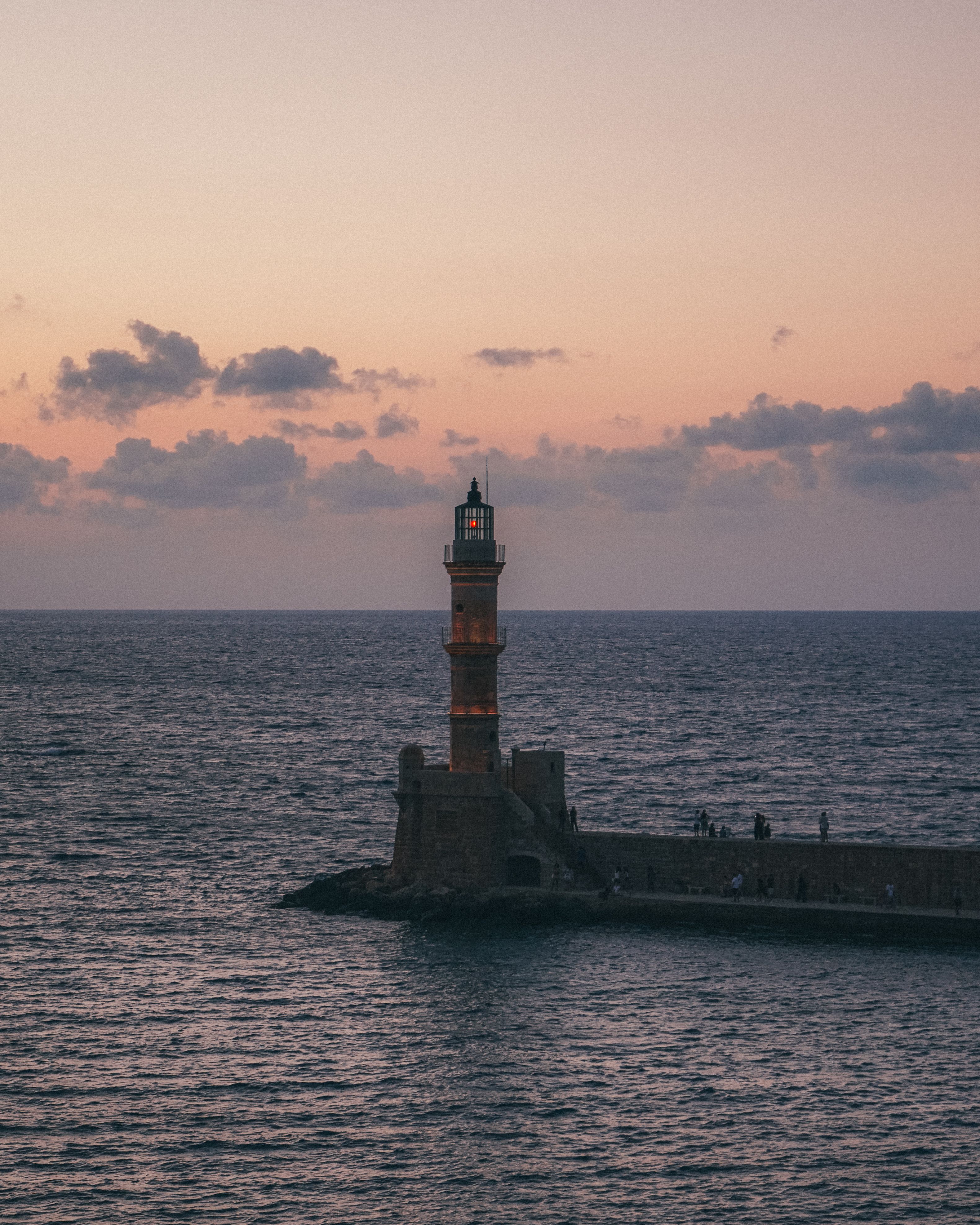 Captivating view of Chania Lighthouse during sunset, perfect for travel enthusiasts.