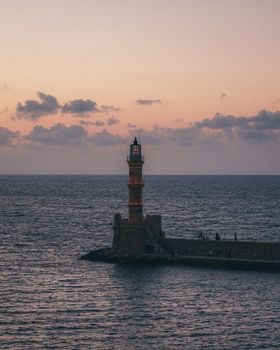 Captivating view of Chania Lighthouse during sunset, perfect for travel enthusiasts.