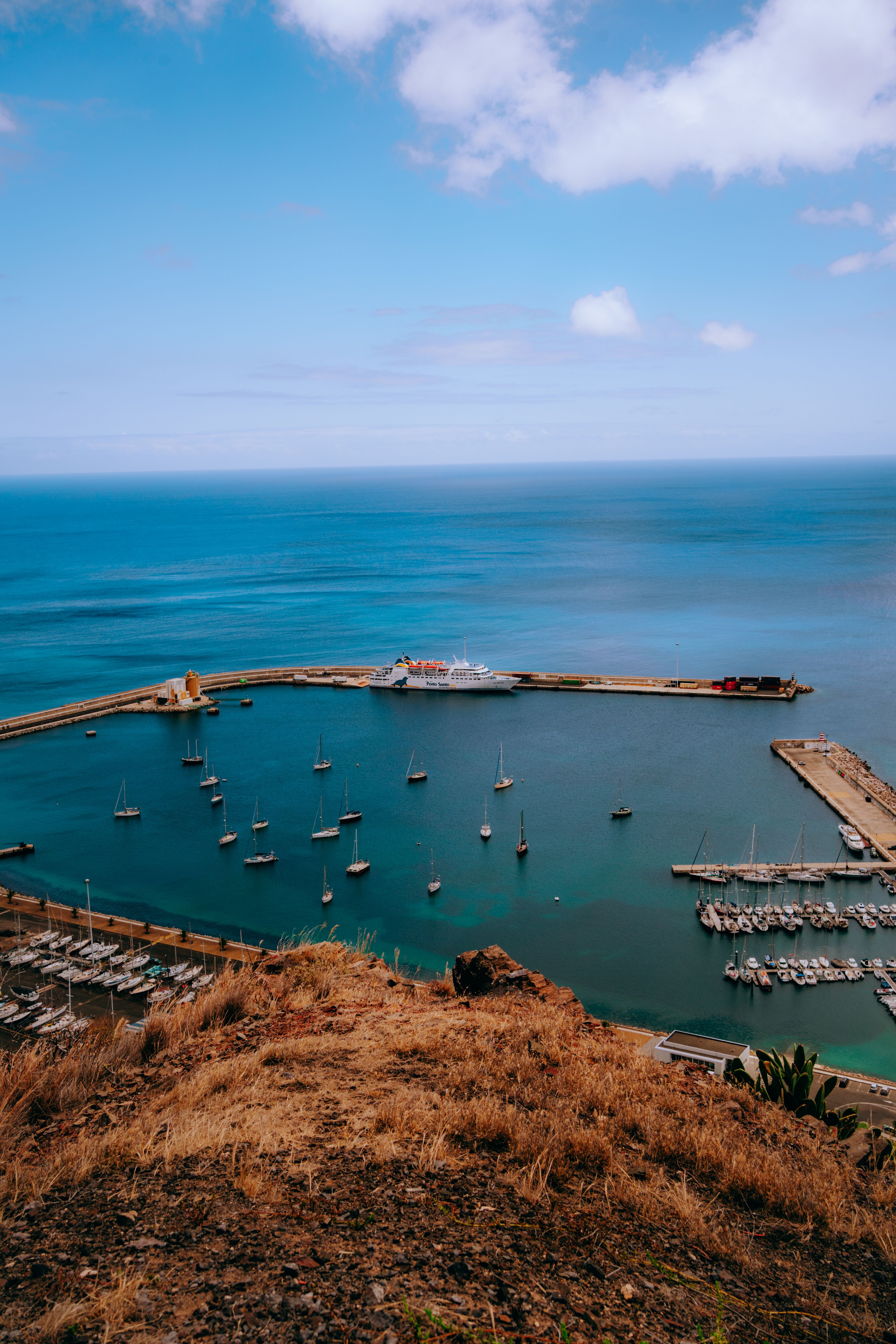 A view of a harbor and boats from a hill · Free Stock Photo