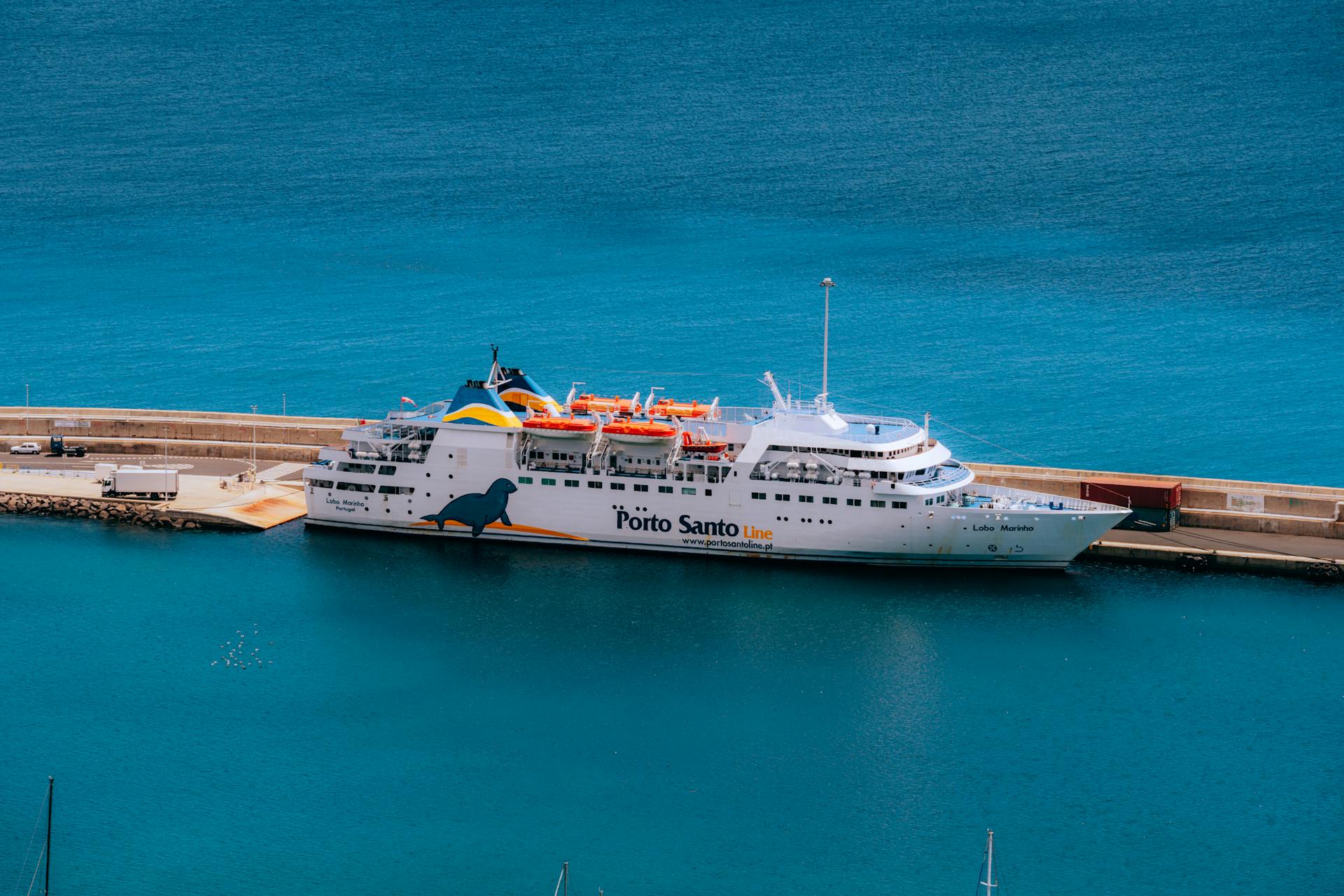 An aerial view of the Porto Santo Line cruise ship docked at a serene harbor, ready for adventure.