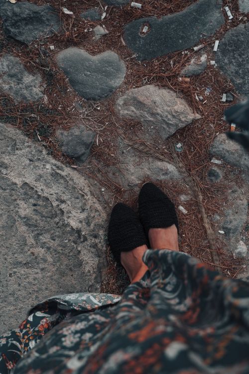 Free Feet in black shoes standing on a rocky path with autumn colors. Stock Photo