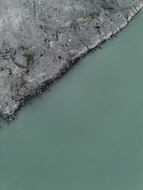 Free Stunning aerial view of glacier meeting turquoise water, showcasing Earth's natural beauty. Stock Photo