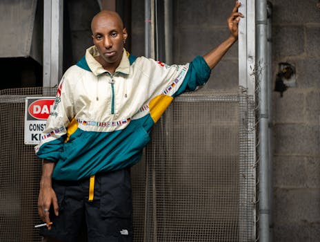 Portrait of a man posing outdoors in an urban Atlanta setting, conveying modern street fashion.