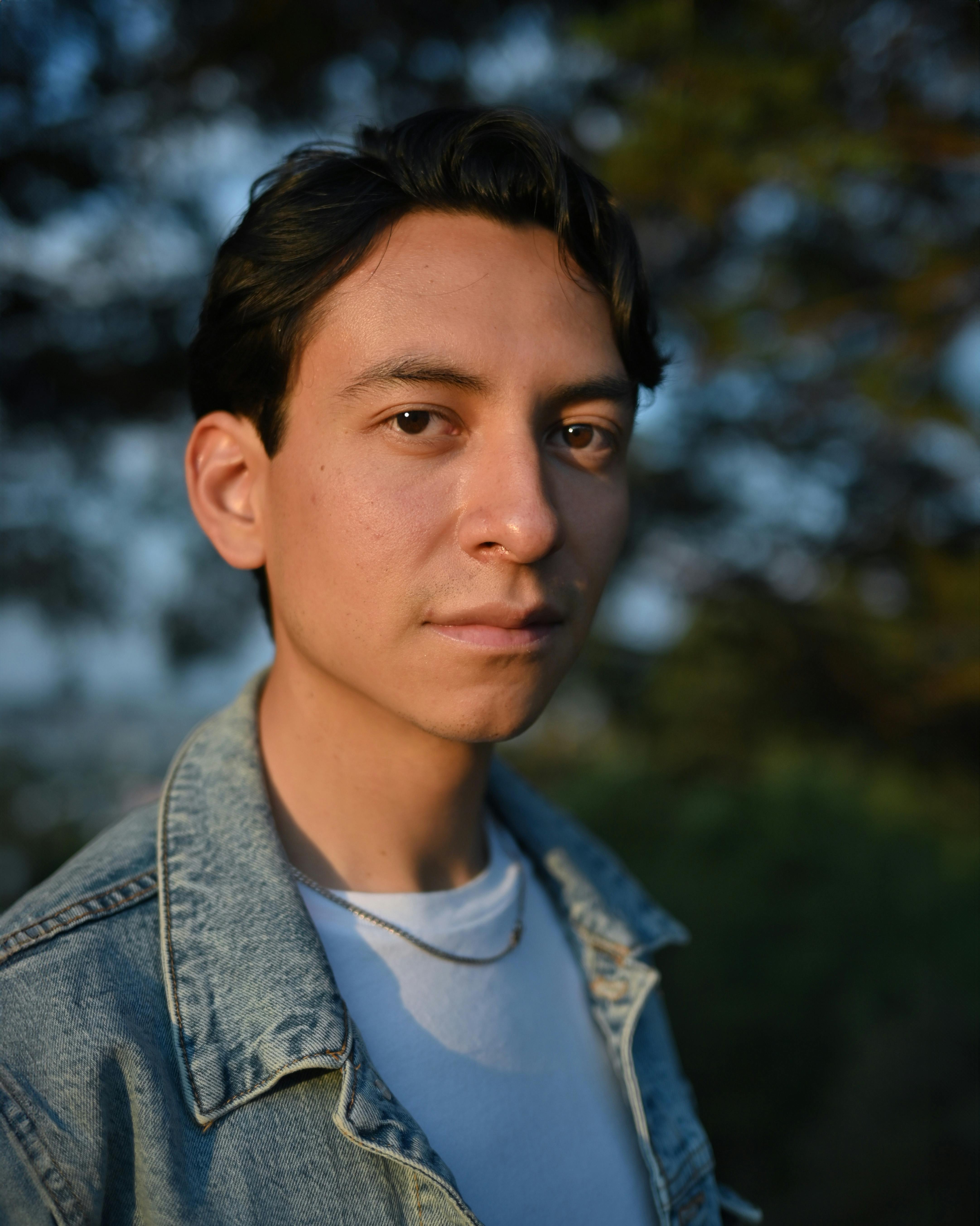 a man in a denim jacket and blue jeans