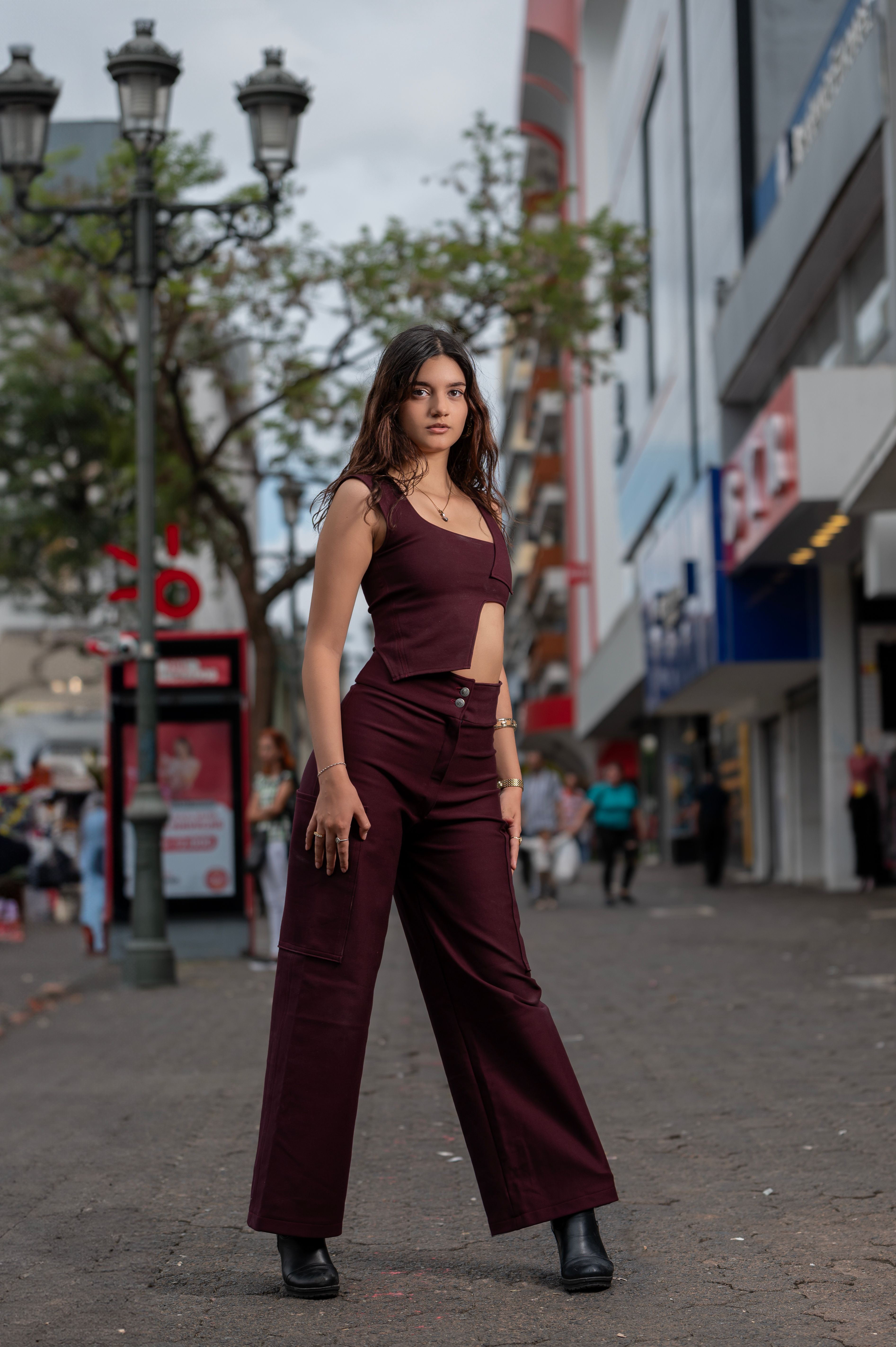 Woman in burgundy wide leg pants with black top