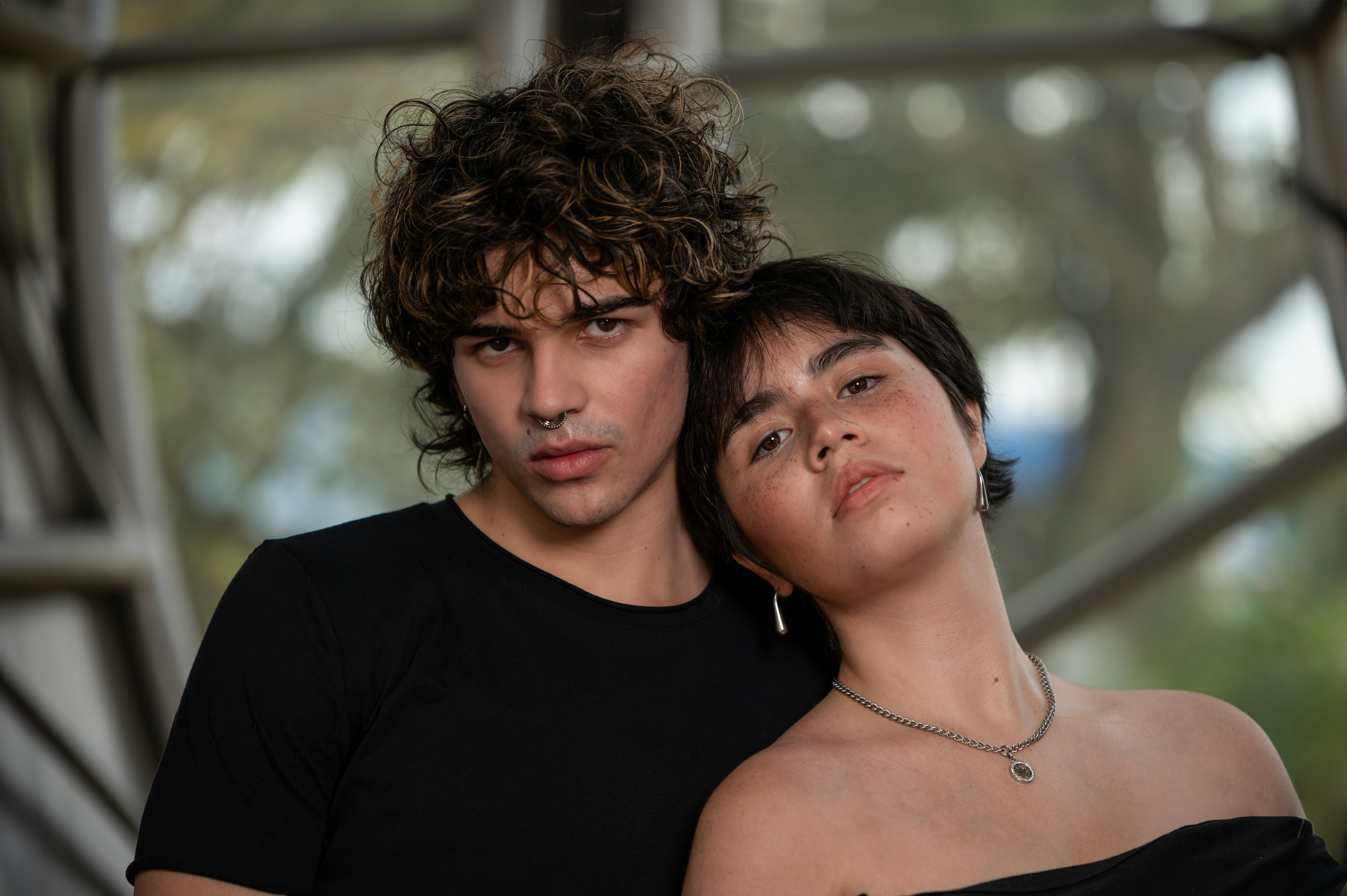 a young man and woman posing for a photo