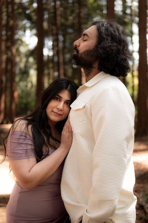 Free A couple shares an intimate moment in a serene forest, symbolizing love and togetherness. Stock Photo