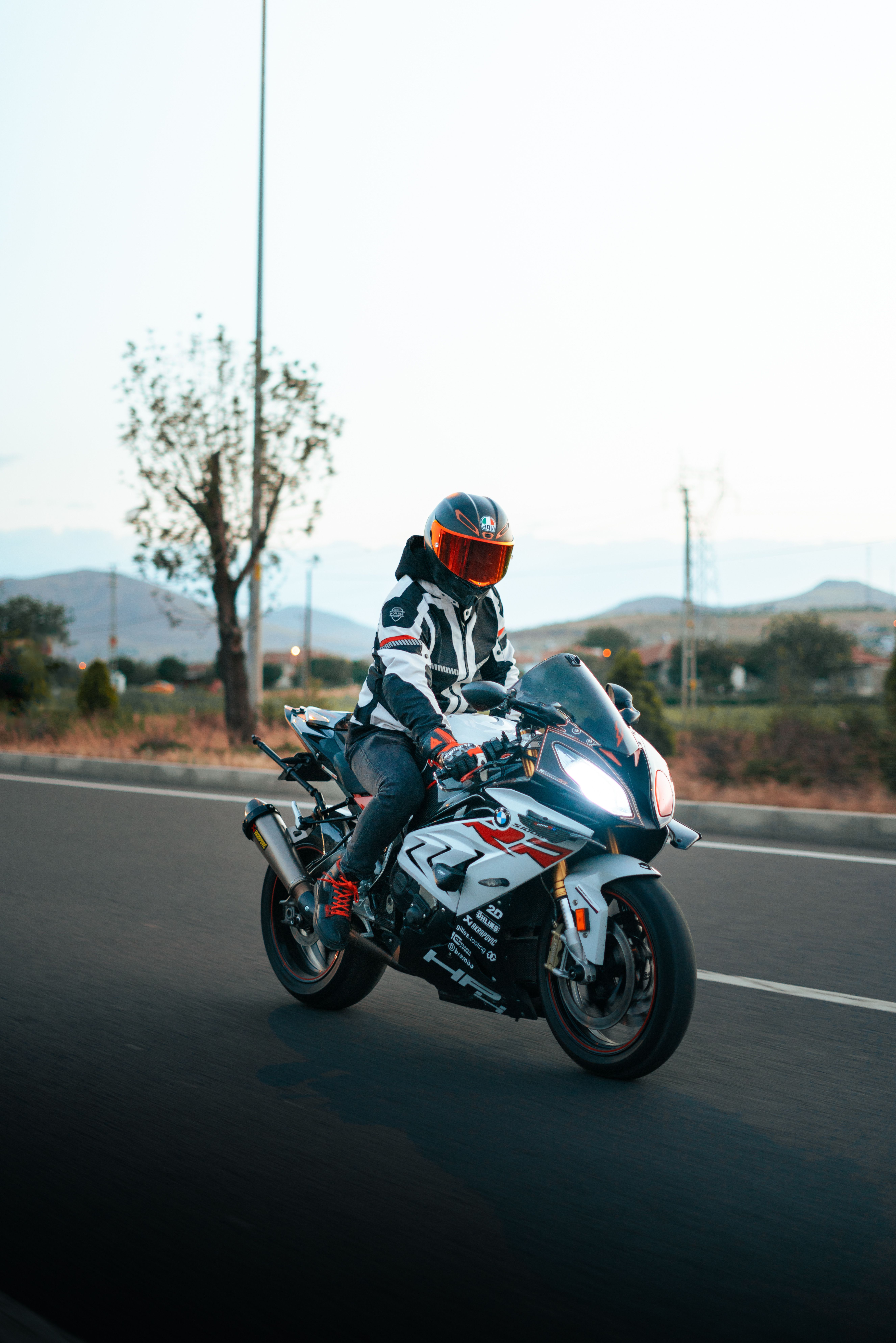A person riding a motorcycle on a road · Free Stock Photo