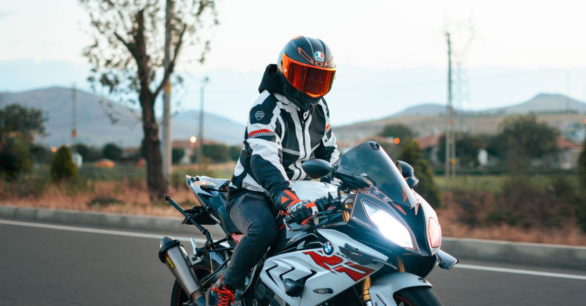 Person Rider A person riding a motorcycle on a road · Free Stock Photo