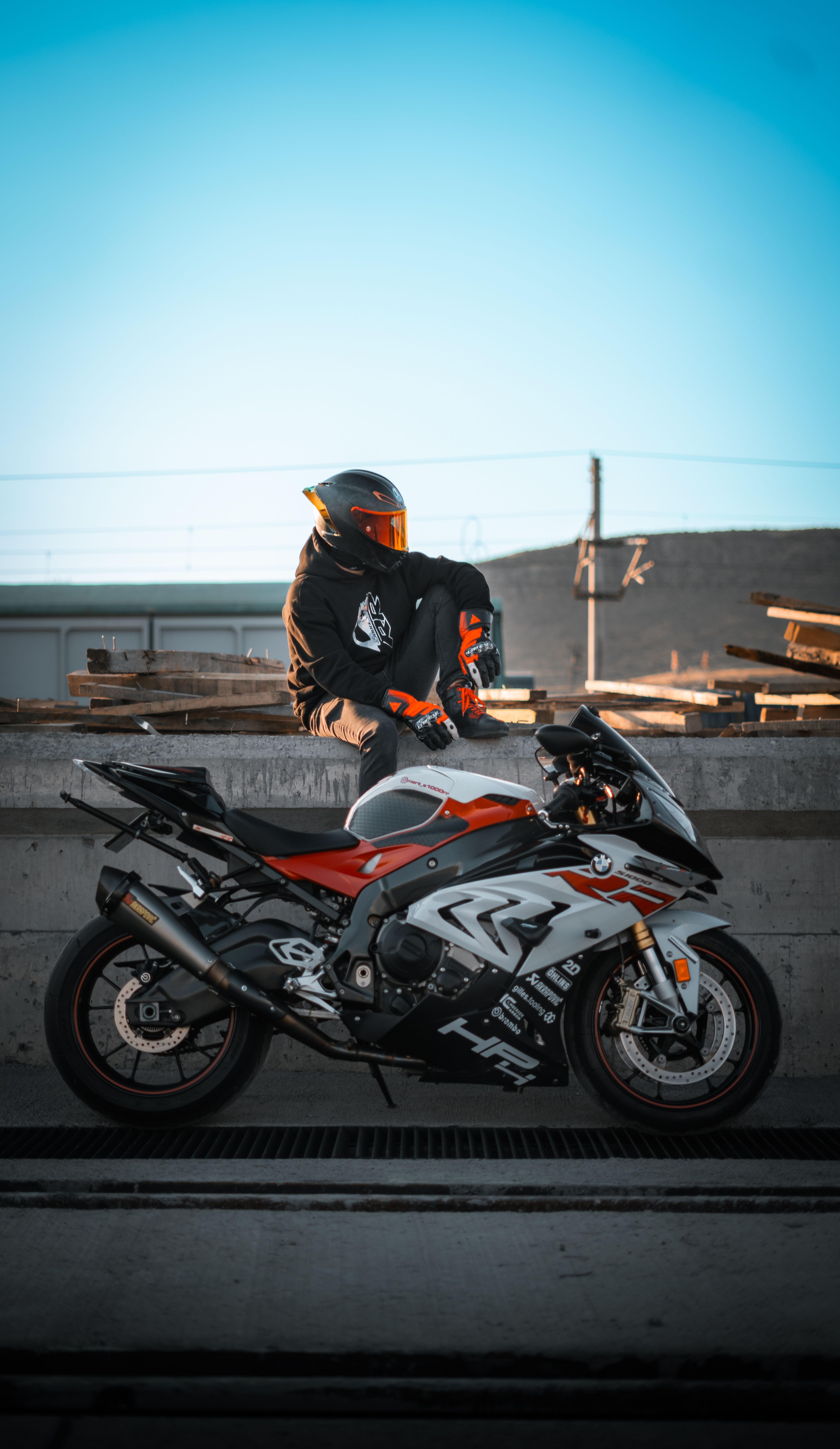 A motorcyclist taking a break with a sleek sport bike, showcasing adventure and speed.