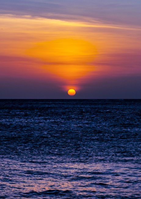 Breathtaking sunset view over the ocean from Aruba, casting vibrant colors across the sky and sea.