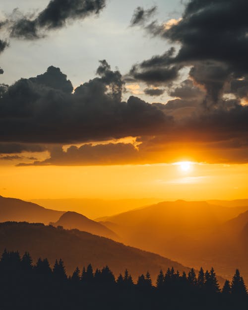 Free Silhouette Photography of Mountain and Trees During Golden Hour Stock Photo