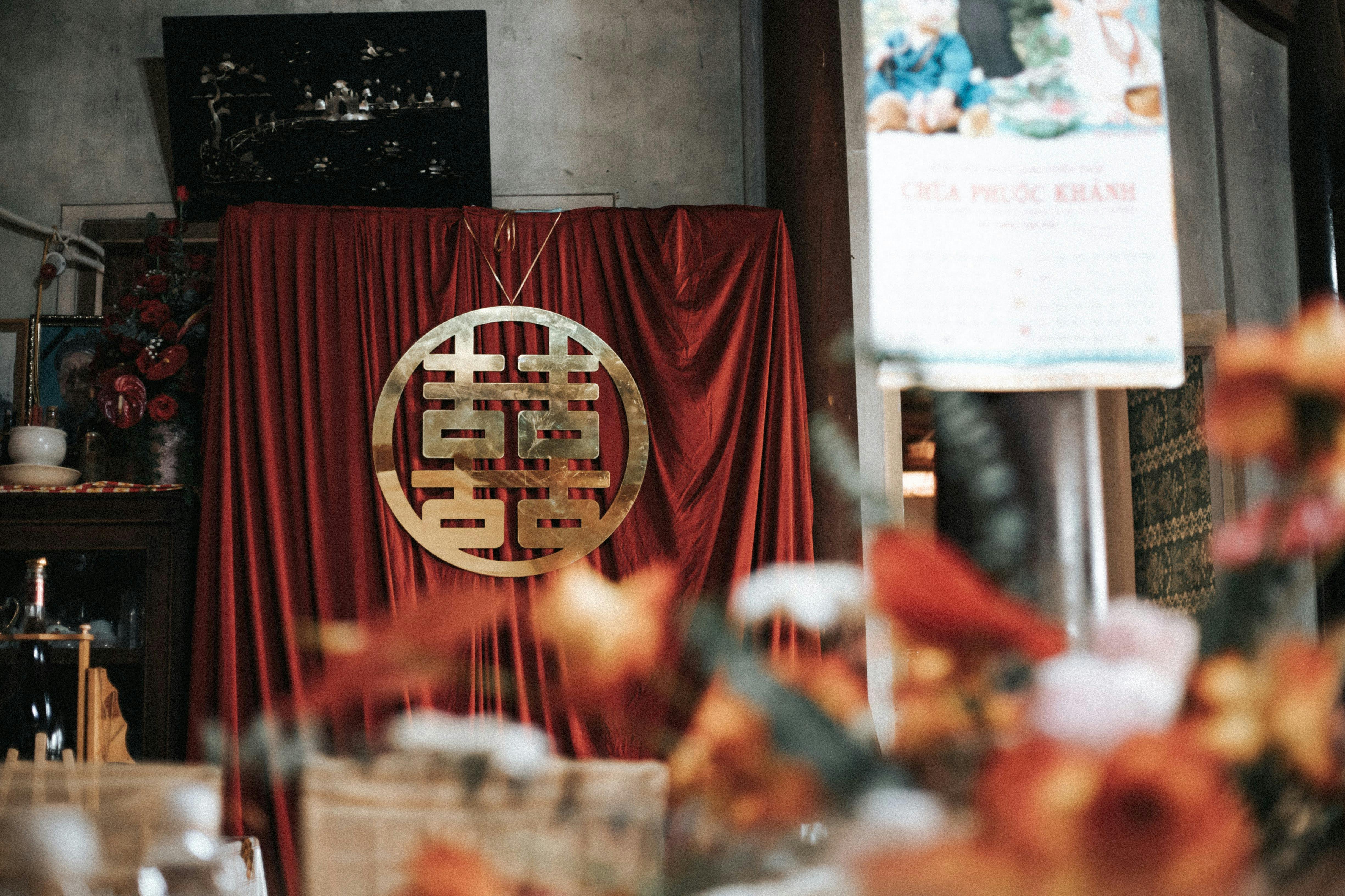 a red curtain with a chinese symbol on it