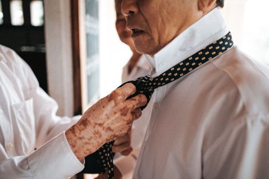 A man tying a tie