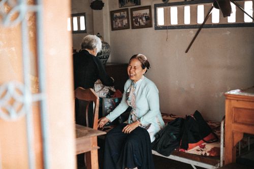Free Two elderly women sharing a joyful moment in a cozy room setting, showcasing warmth and companionship. Stock Photo