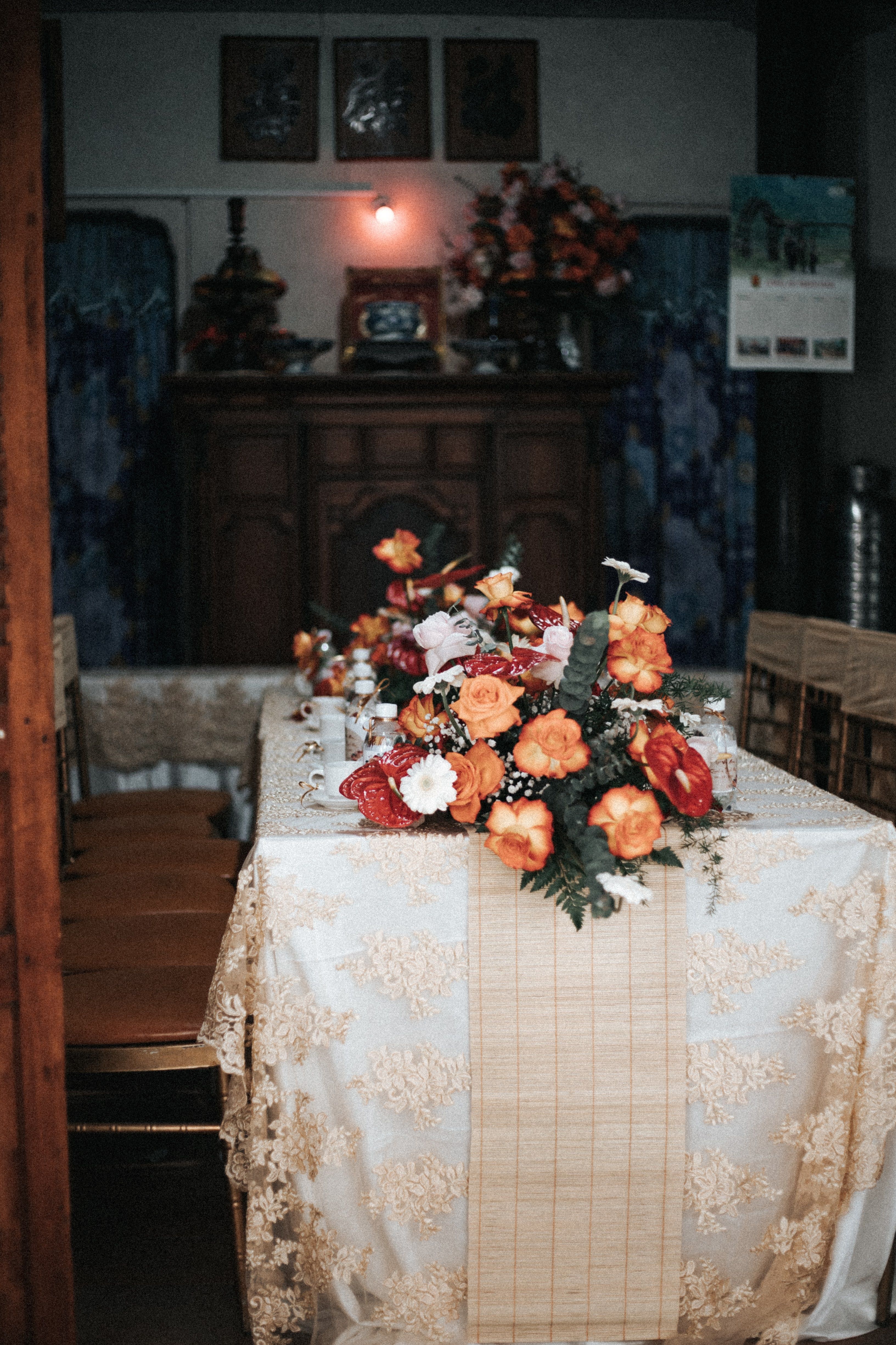 Free Vintage dining room with ornate table setup and lush floral centerpiece creating a luxurious ambiance. Stock Photo