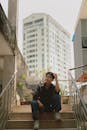 A man sitting on the steps of a building