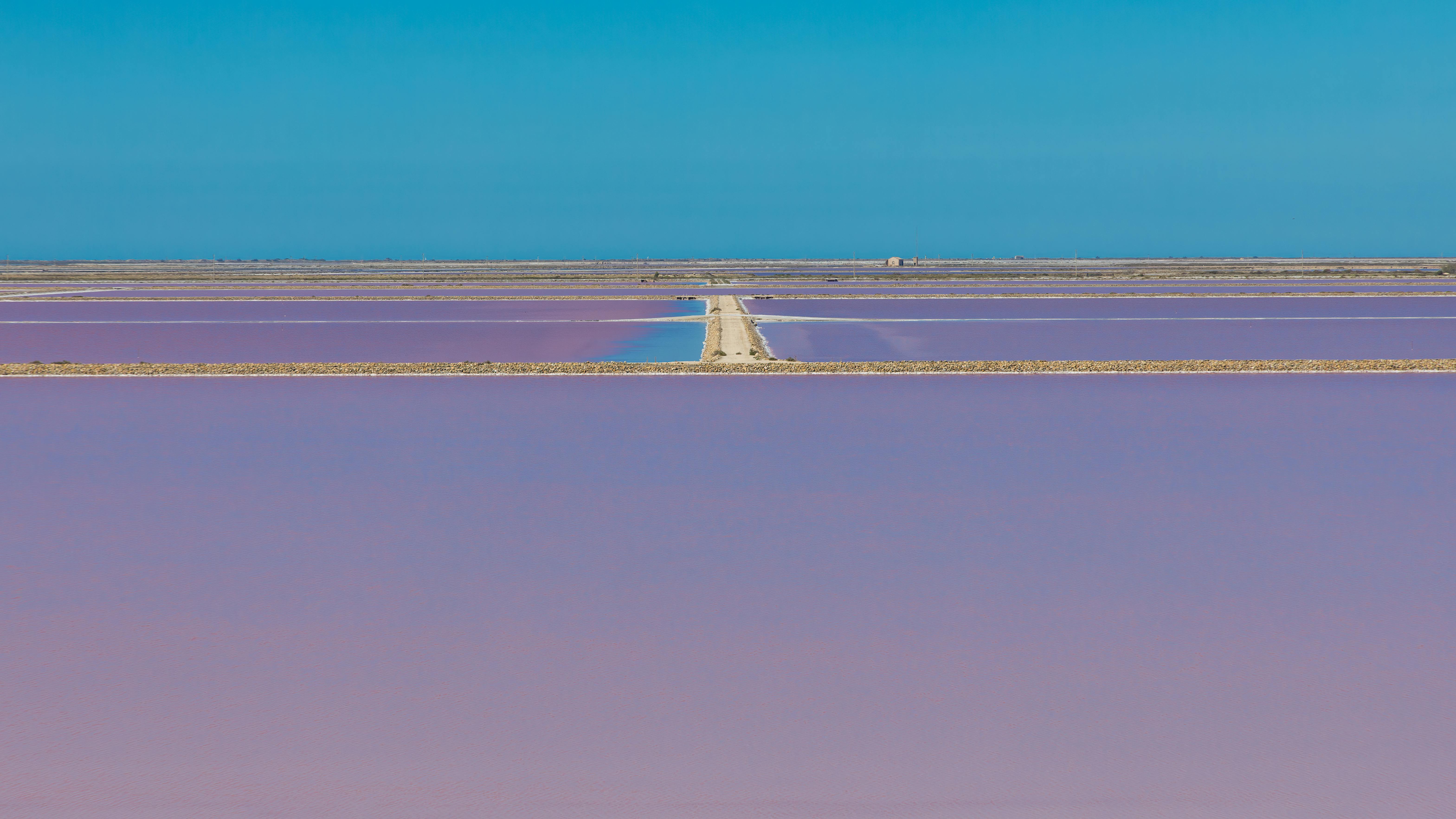 Stunning aerial view of purple salt pans in Saintes-Maries-de-la-Mer, France.