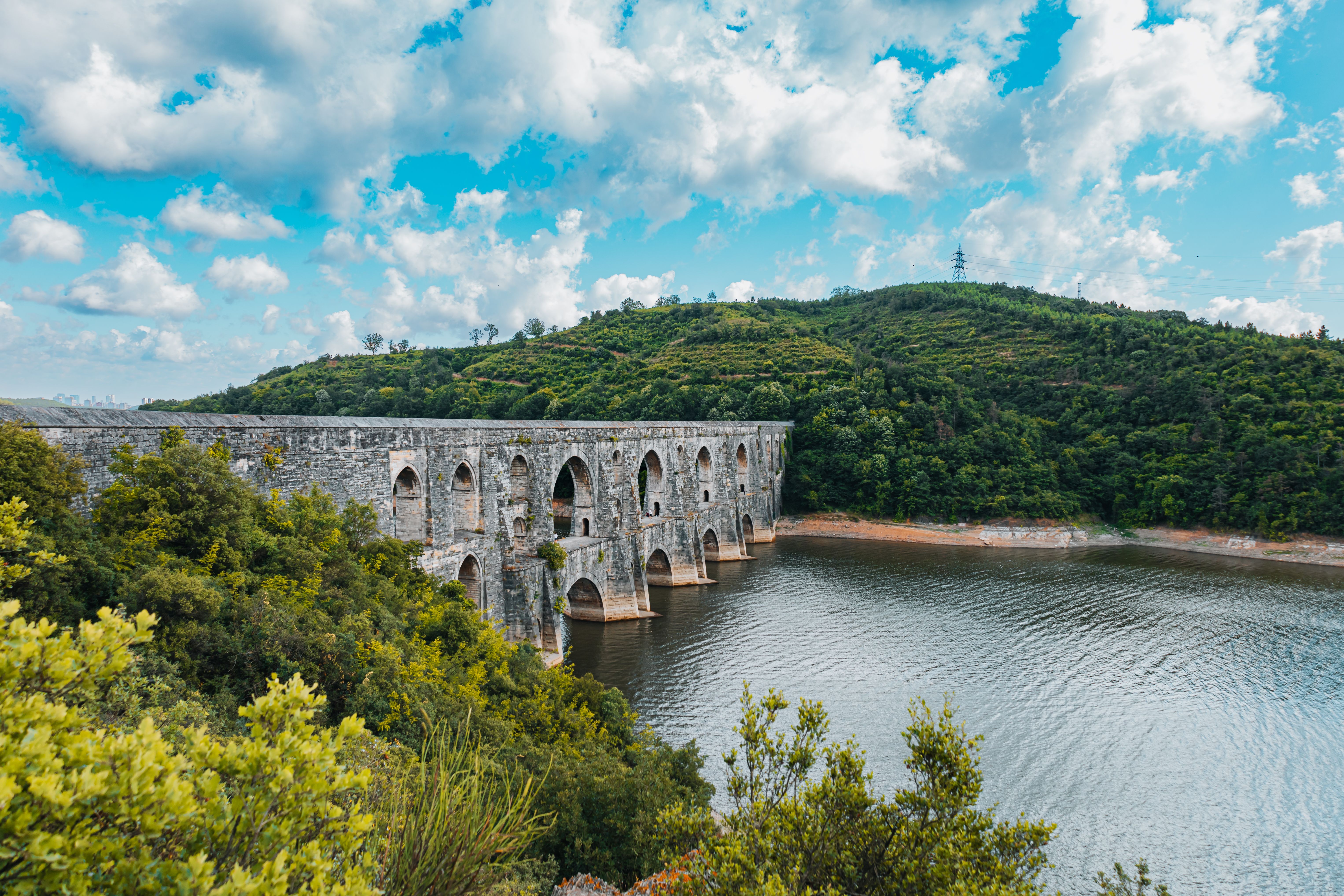 The old stone bridge over a river in the middle of a forest · Free ...