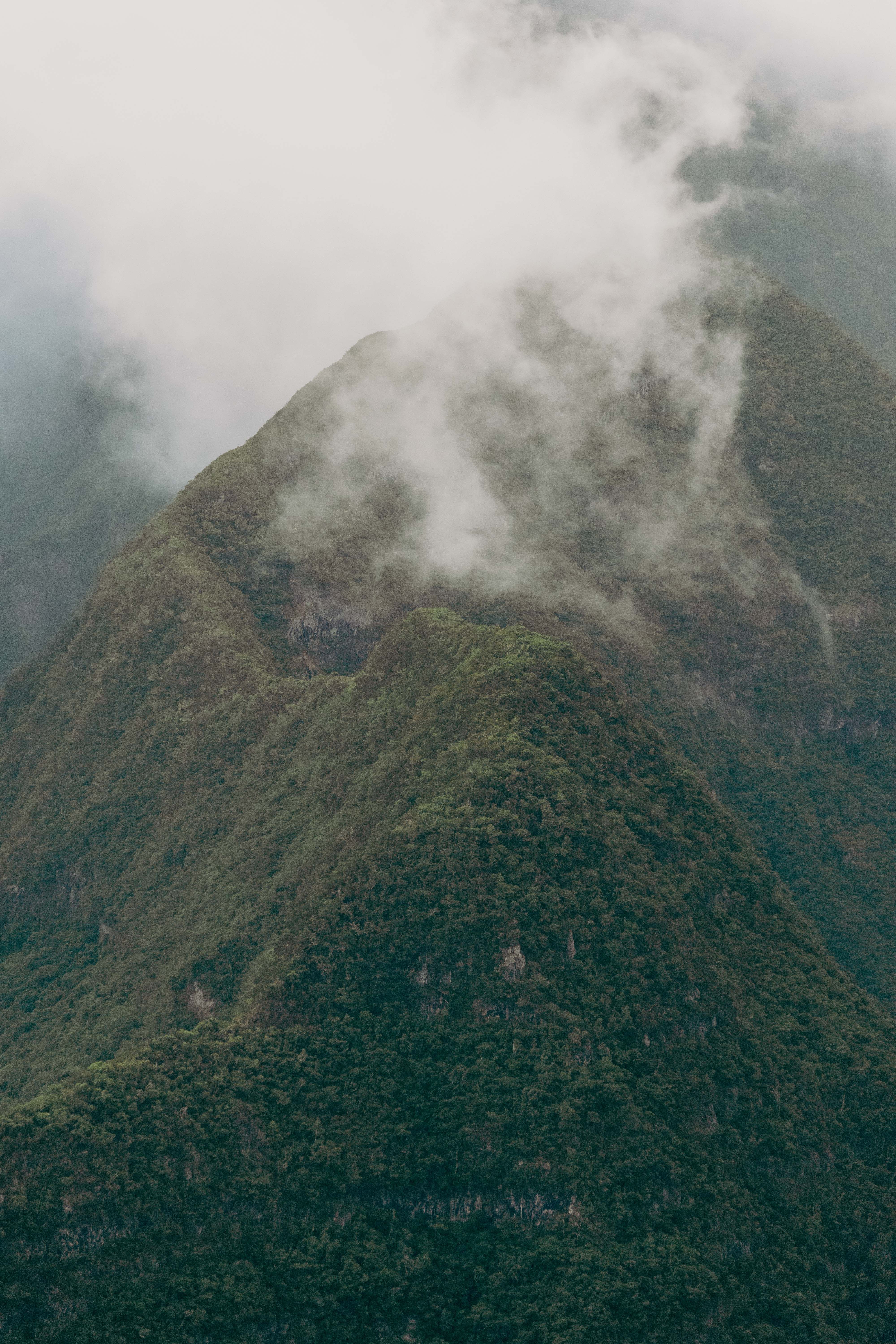 A mountain with clouds and fog on it · Free Stock Photo