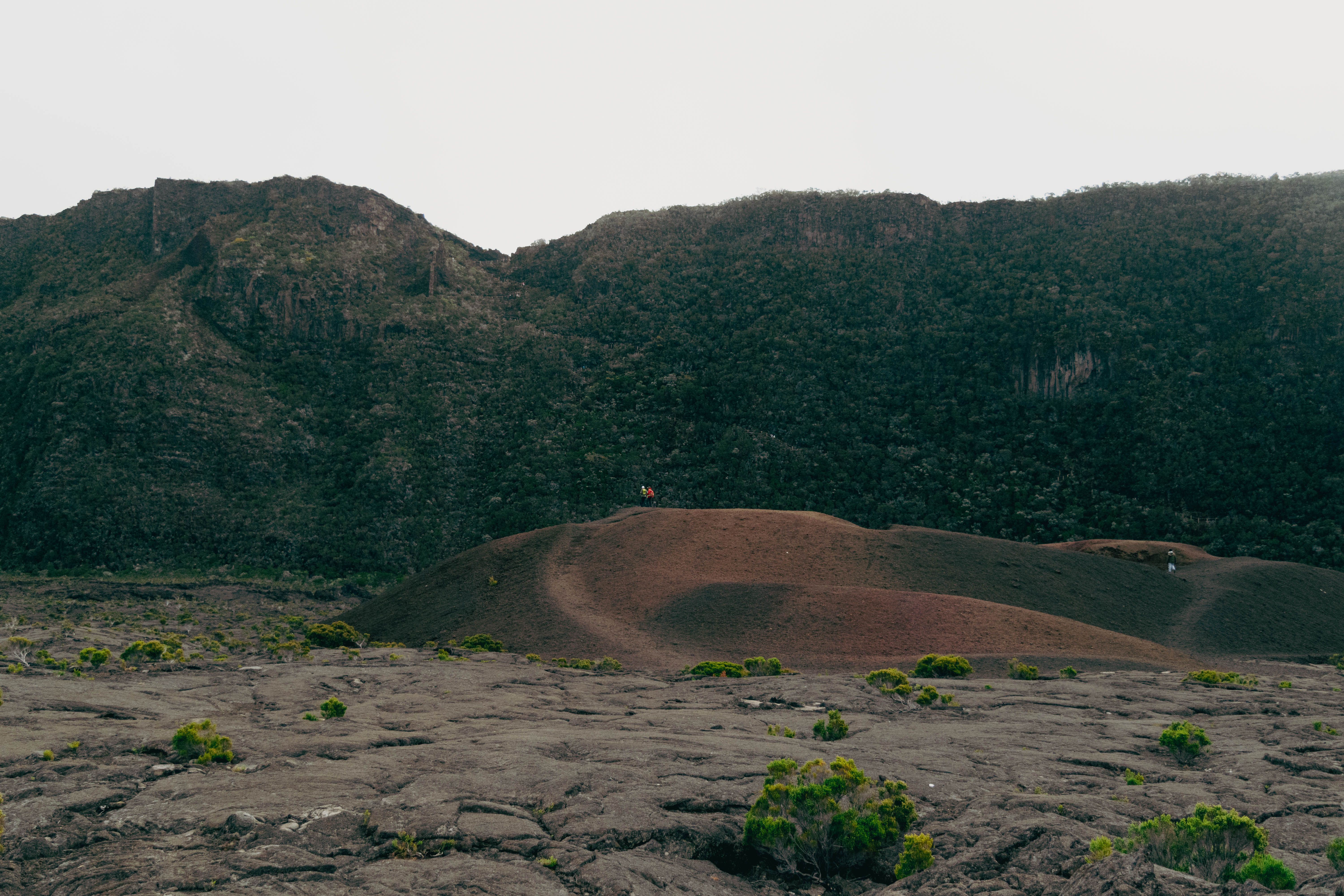 A person standing on top of a hill with a mountain in the background, Comoros