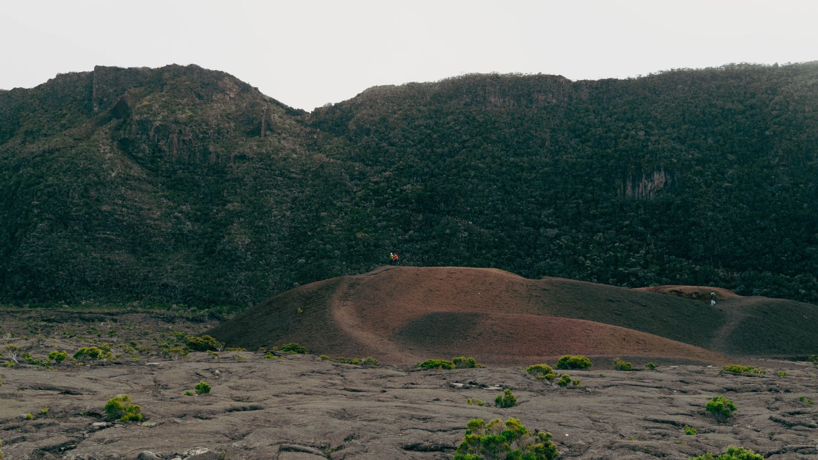 A person standing on top of a hill with a mountain in the background, Comoros