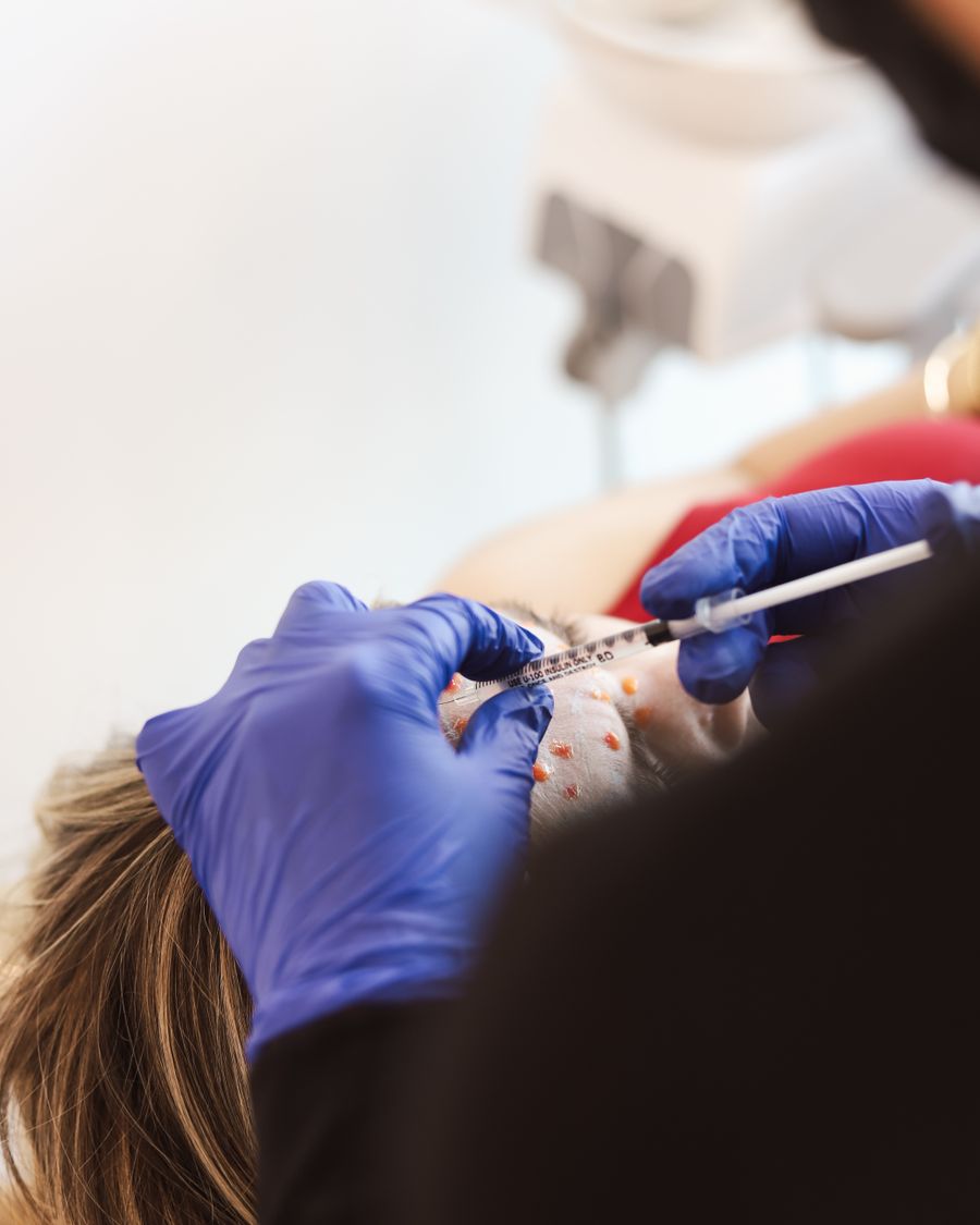 Doctor injecting along the lower face, representing face contour injections at Bailor Clinic in Sinsa, Gangnam
