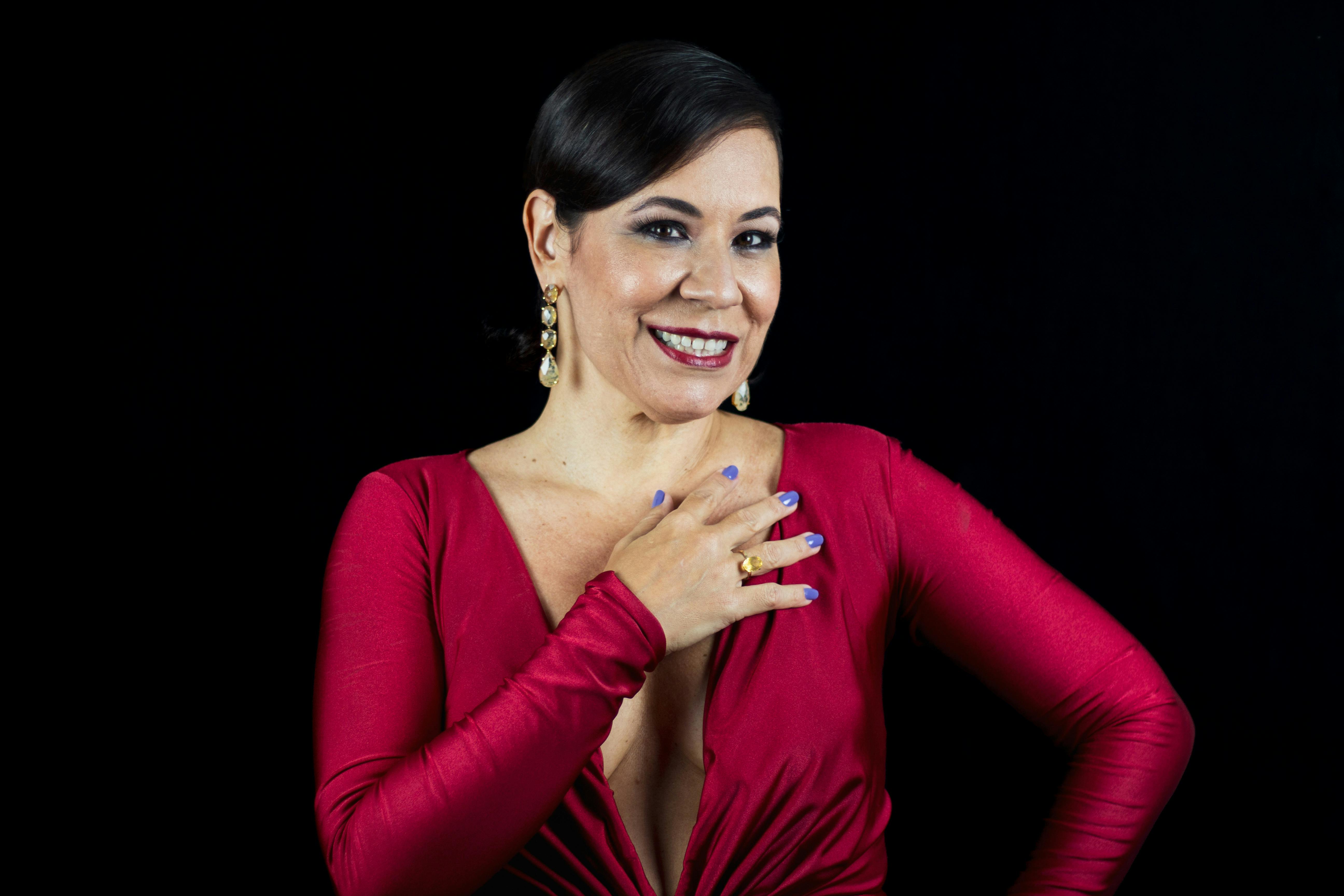 a woman in a red dress posing for a photo