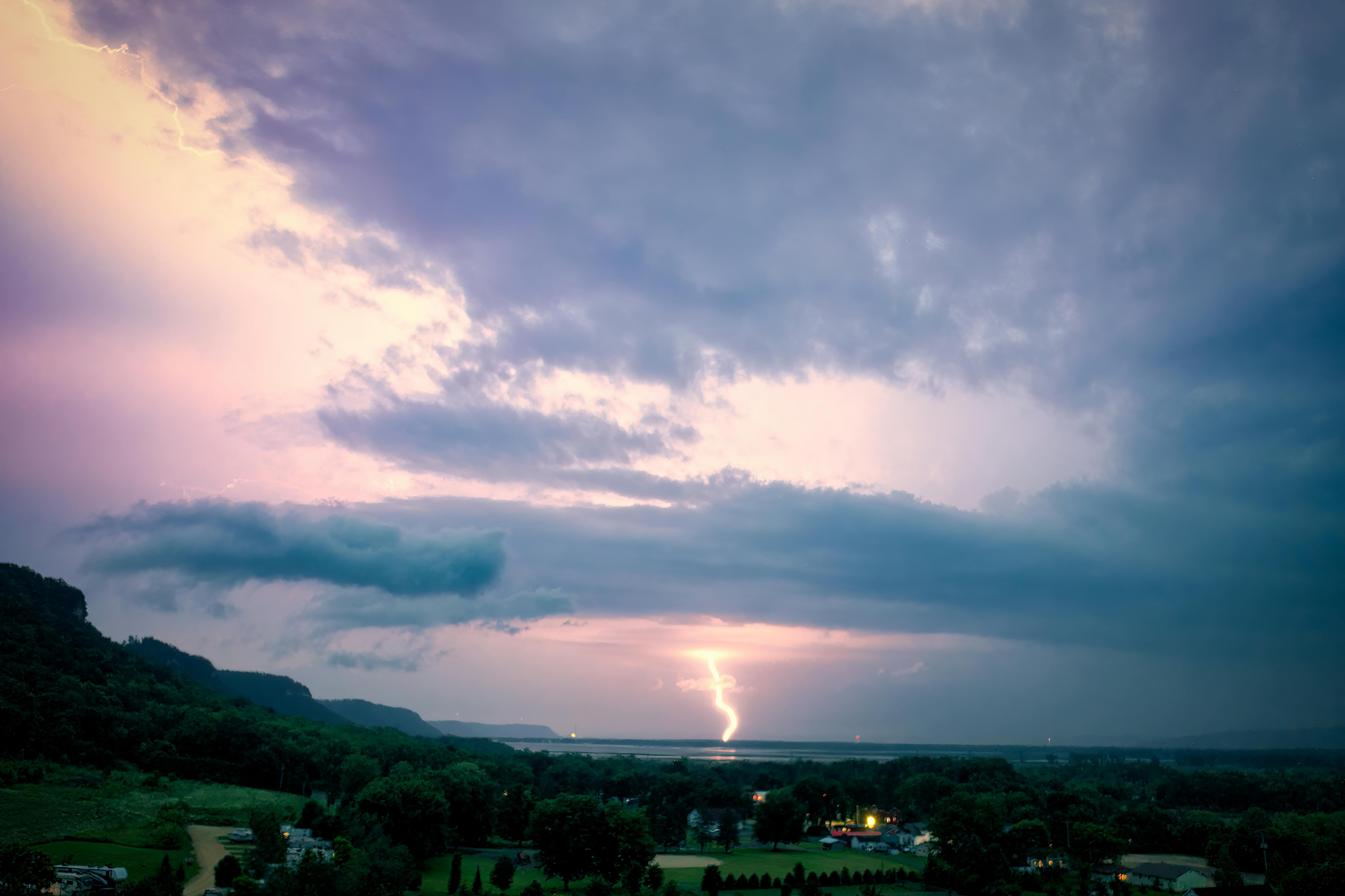 a lightning bolt is seen over a valley