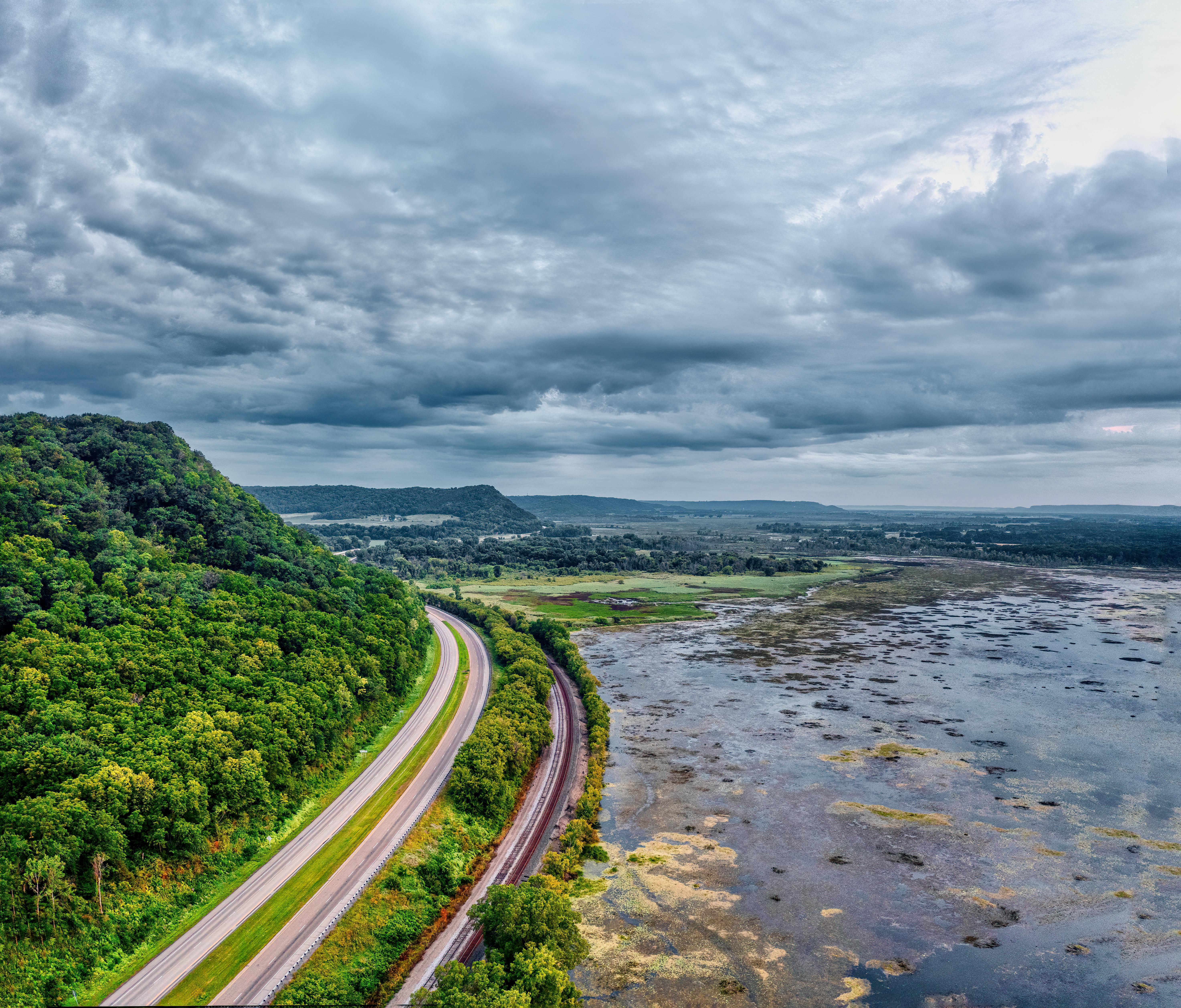 a highway runs through a valley with a river