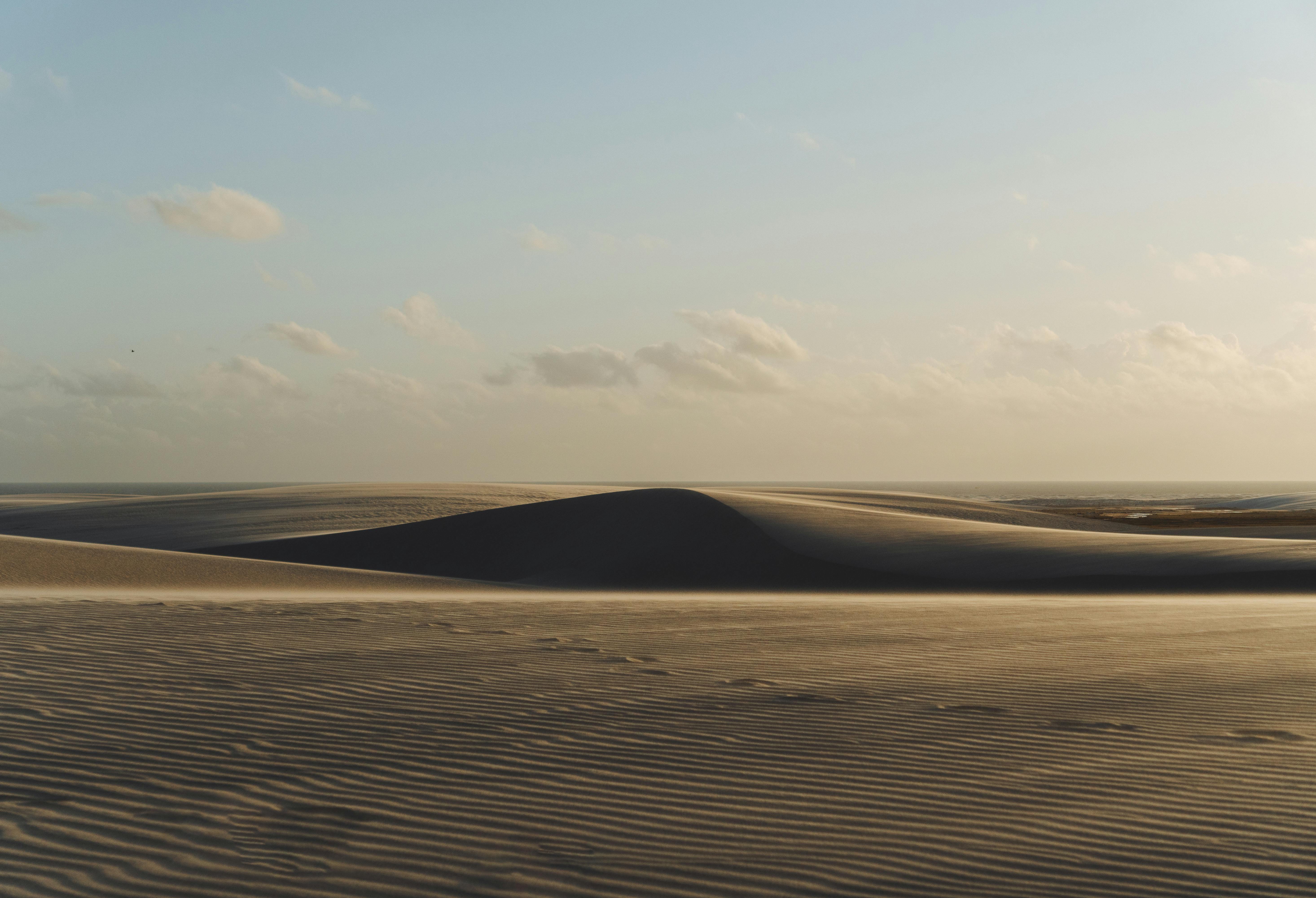 Captivating view of São Luís sand dunes under a warm sunset sky.