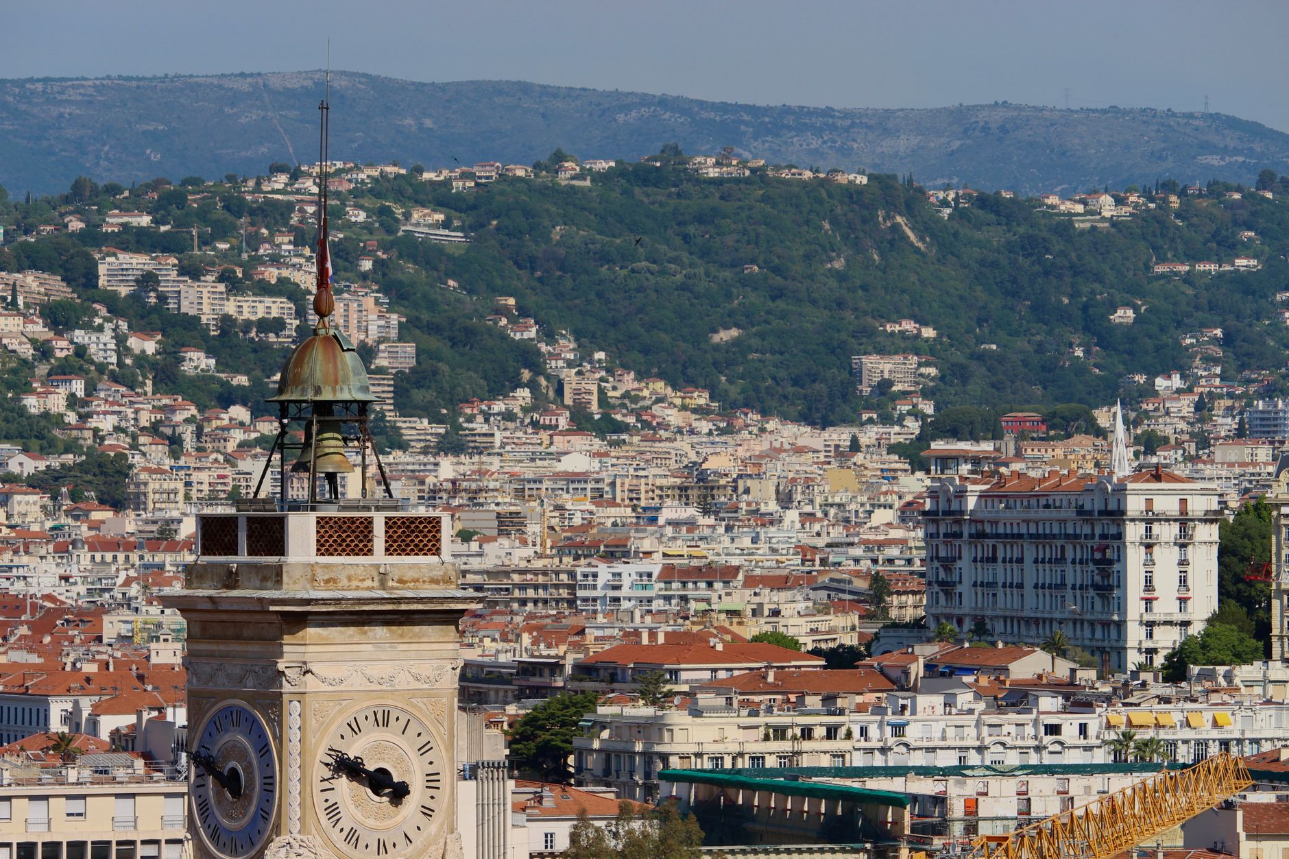 A stunning view of a historic clock tower with the cityscape of Nice, France in the background., Nice, France, stay connected here with a travel eSIM