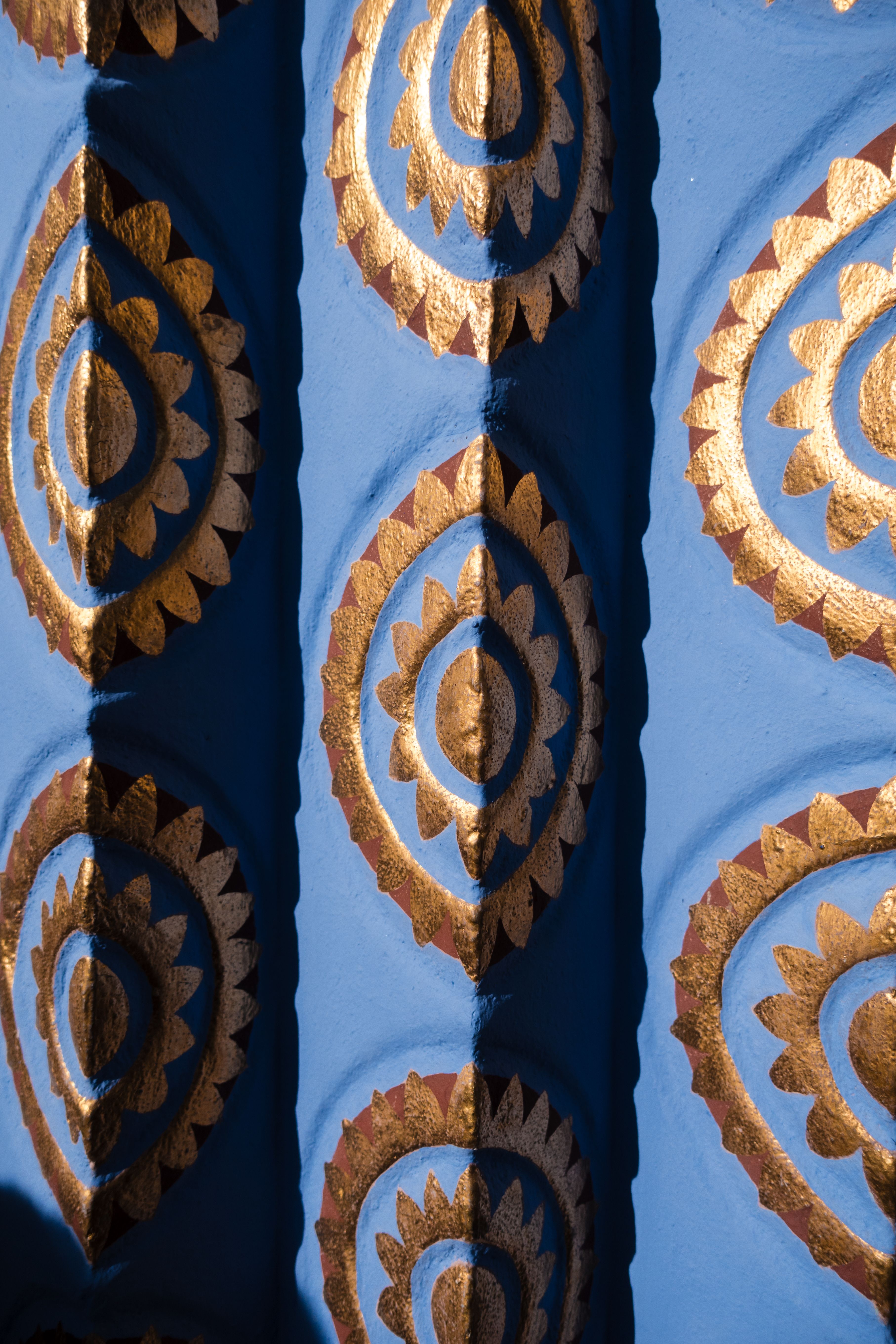 A close up of a blue and gold decorative wall · Free Stock Photo