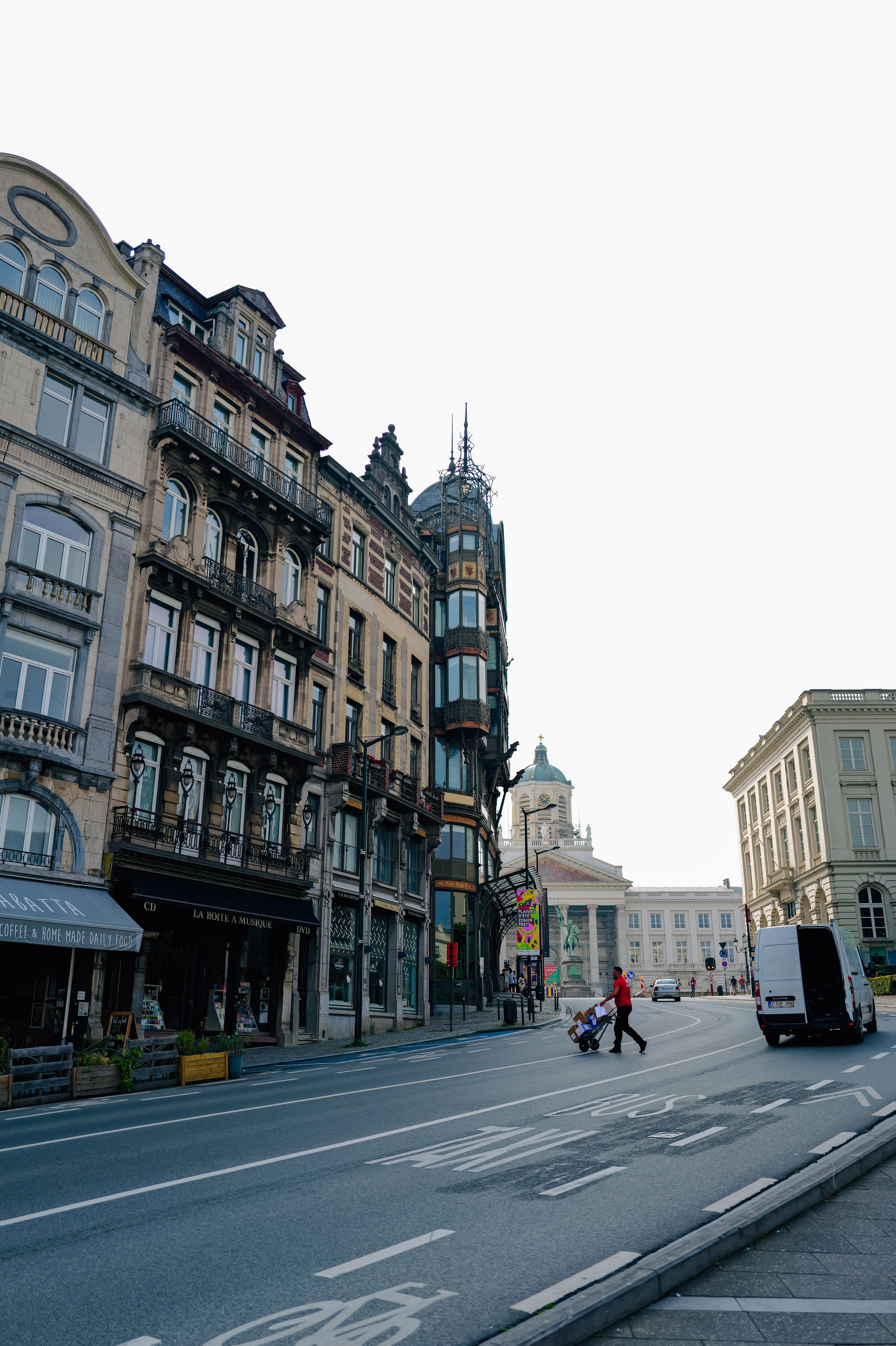 Charming view of a European street with historic buildings and a person crossing the road.