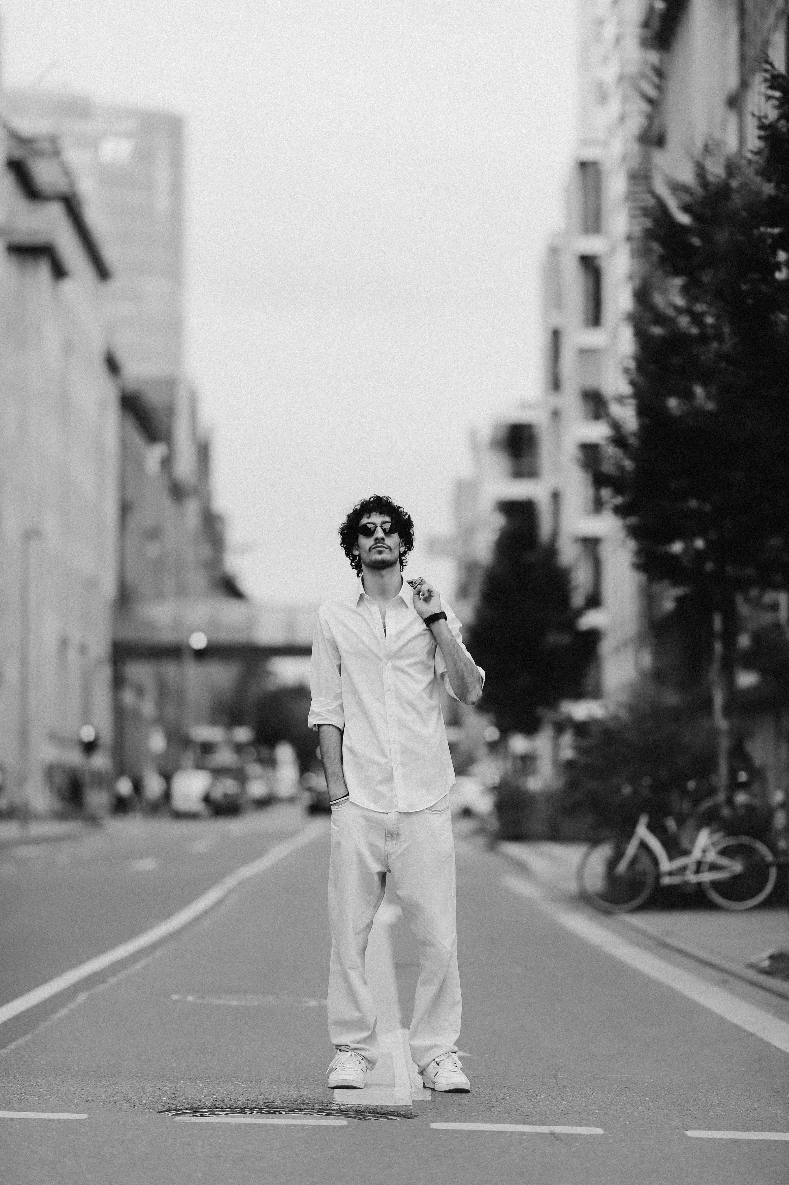 man in shirt posing in middle of street in dusseldorf germany