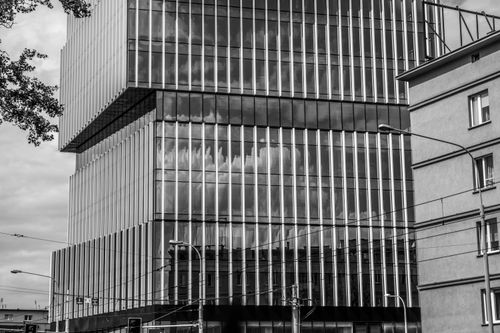 Free Black and white photo of a modern glass skyscraper in Wrocław, Poland. Stock Photo