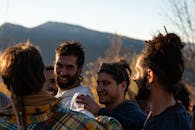 A group of men are standing together in the mountains