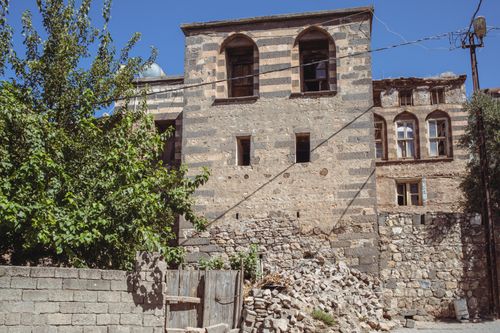 Free A historic stone building with distinct Gothic architecture in Çermik, Türkiye on a sunny day. Stock Photo