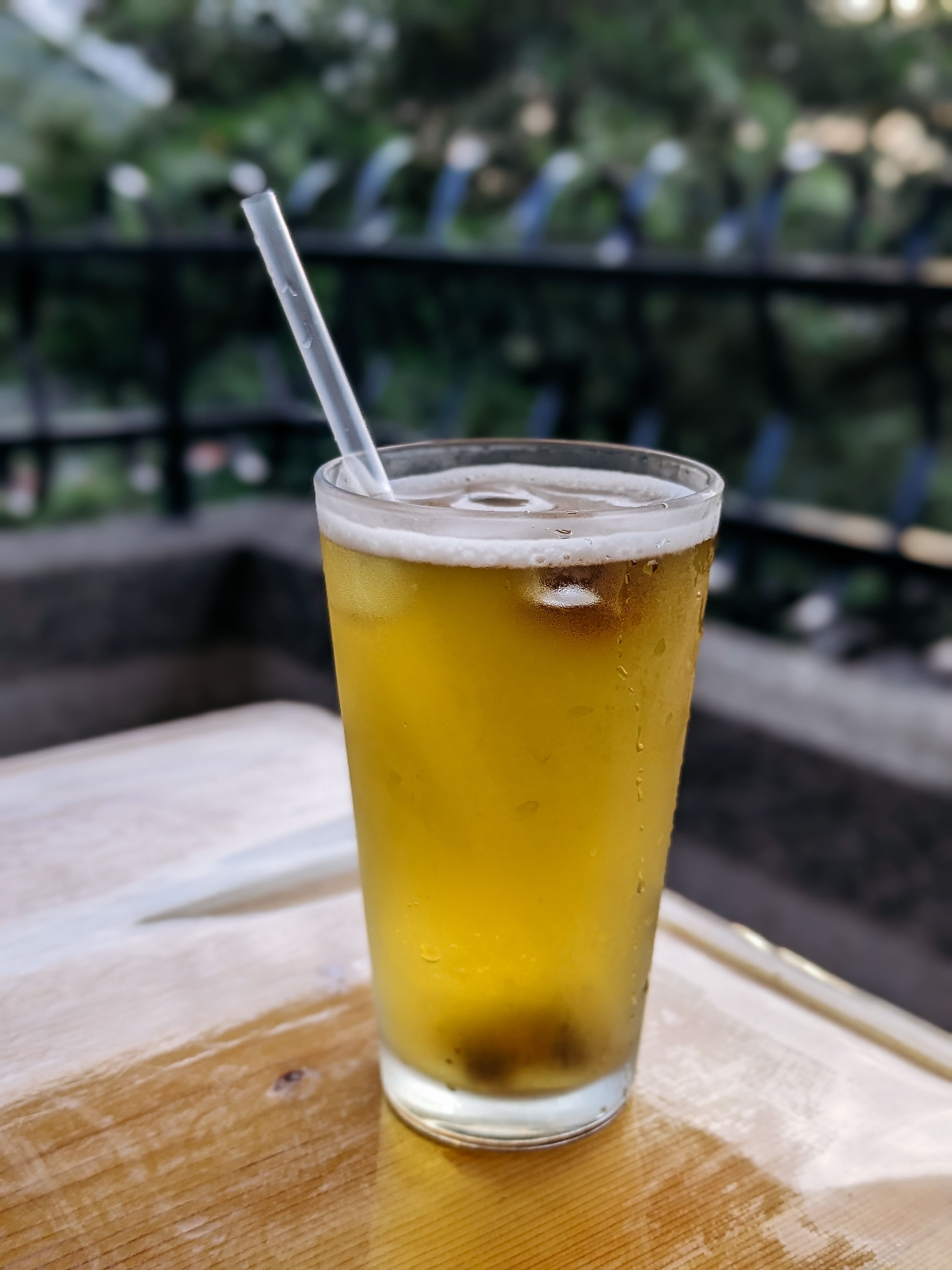 A glass of beer with a straw on top · Free Stock Photo
