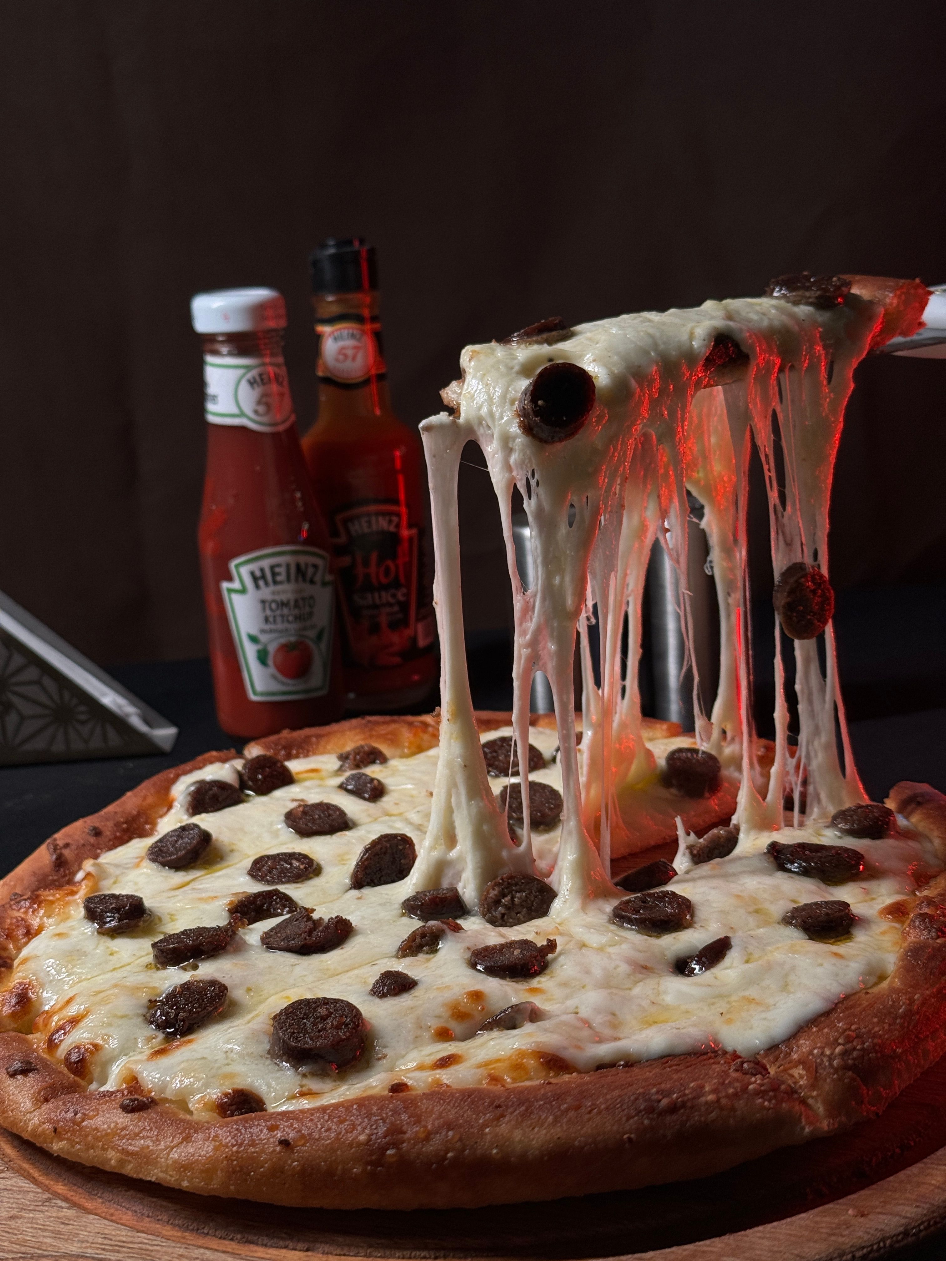 Sizzling pepperoni pizza with melted cheese pulled up, perfect for parties or dinners.
