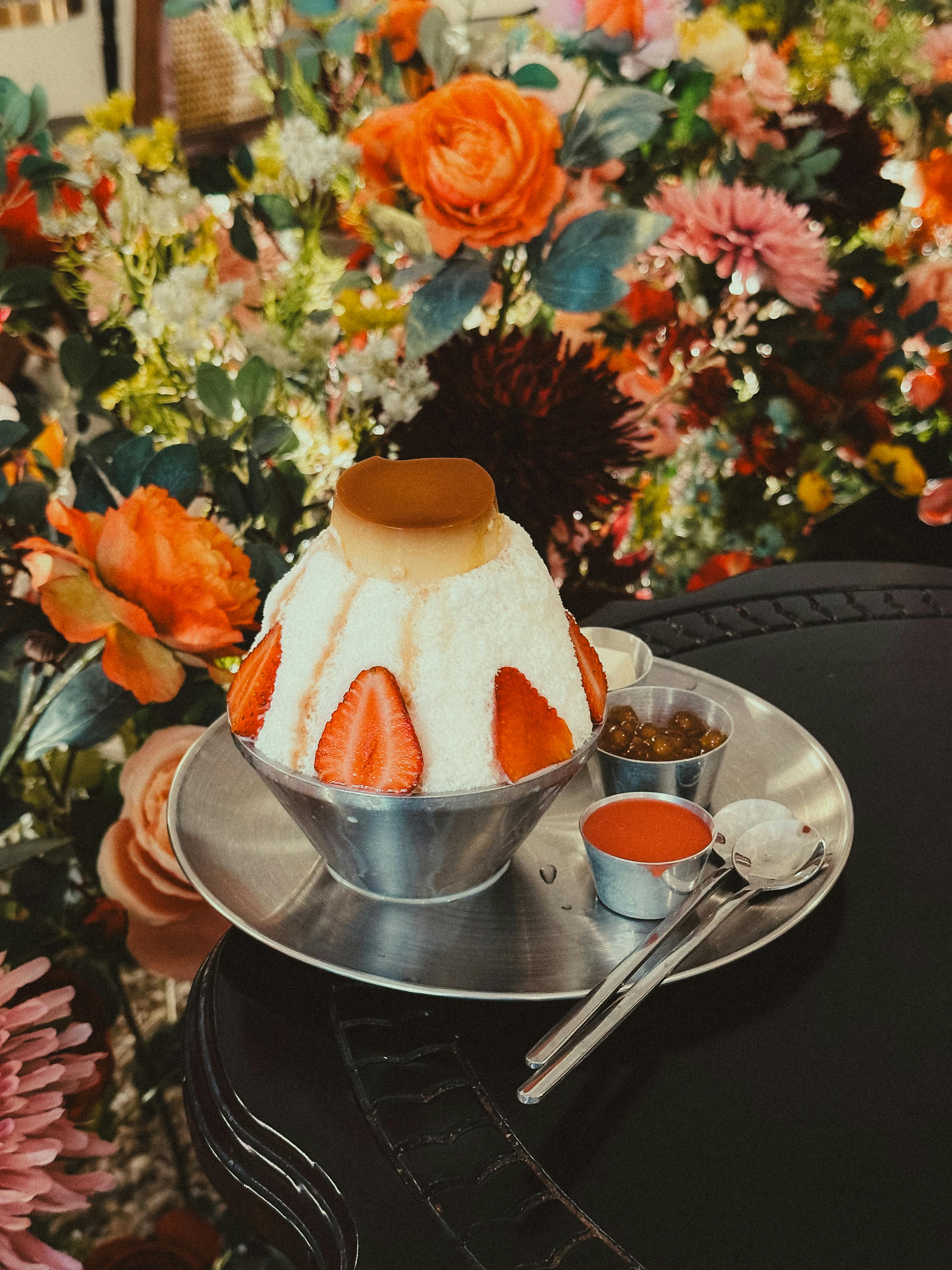 a dessert with a flower on top of it on a table