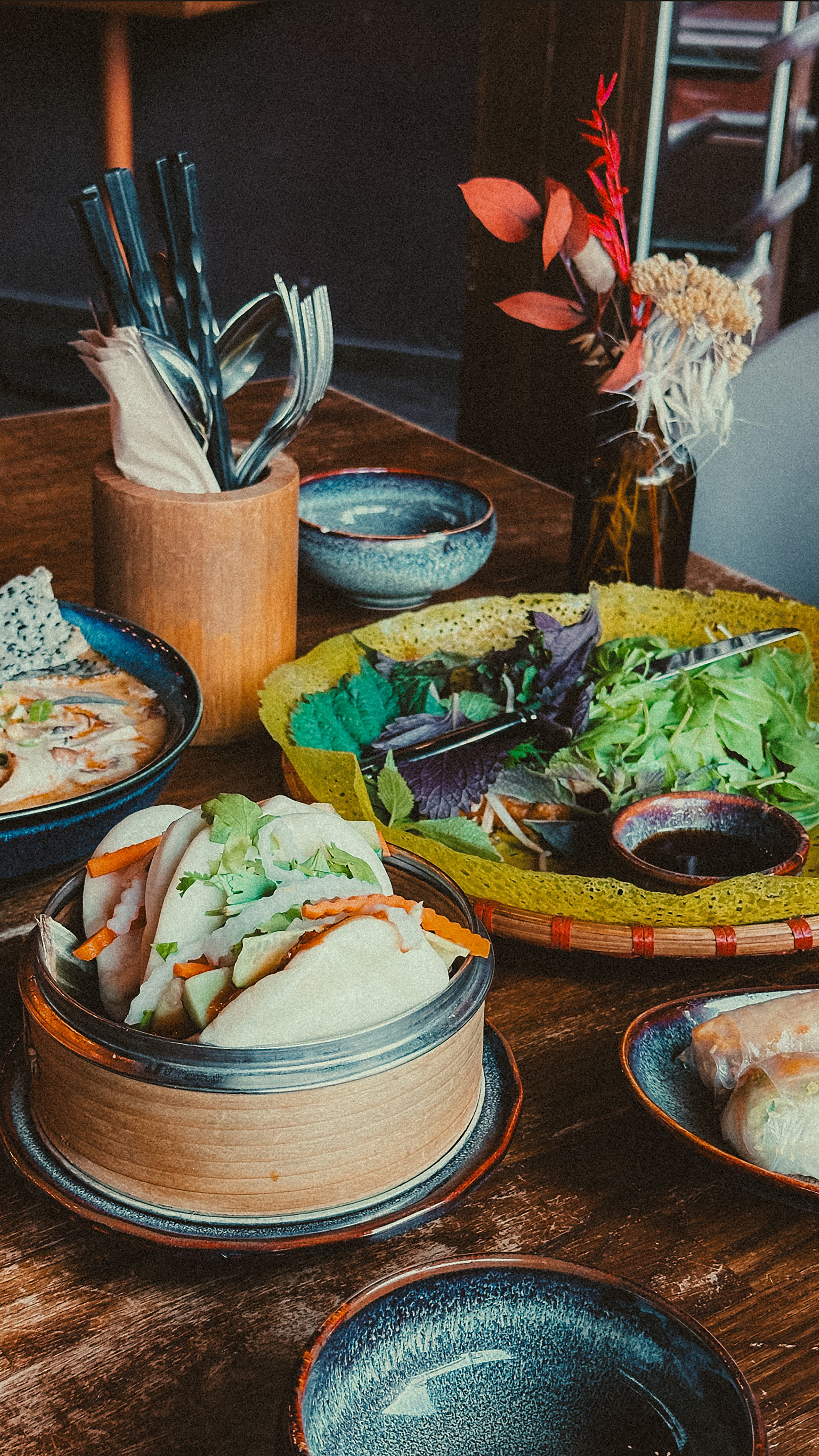 A colorful spread of Asian dishes on a wooden table, perfect for a traditional feast.